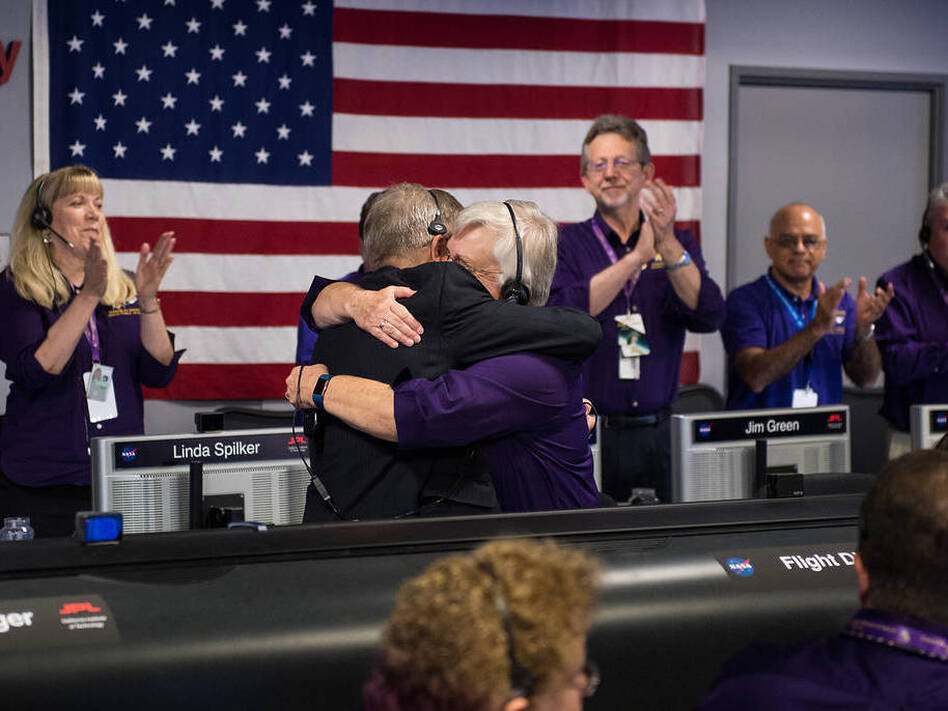 Earl Maize (left), Cassini program manager at JPL, and Julie Webster, spacecraft operations team manager for the Cassini mission at Saturn, embrace after the Cassini spacecraft plunged into Saturn on Friday at precisely 7:55 a.m. ET. (NASA/Joel Kowsky/(NASA/Joel Kowsky))
