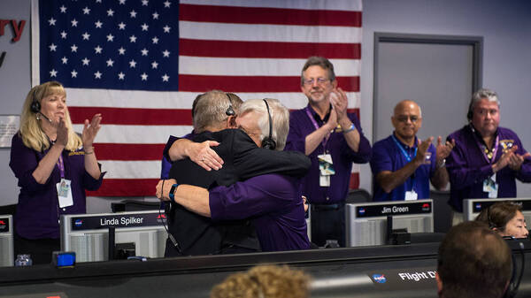 Cassini program manager at JPL, Earl Maize, left, and spacecraft operations team manager for the Cassini mission at Saturn, Julie Webster embrace after the Cassini spacecraft plunged into Saturn, on Friday at precisely 7:55 a.m. ET.