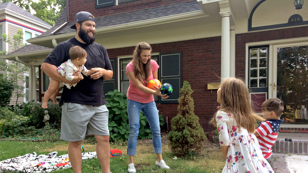 Entrepreneur Stinson Dean (left) and his wife Stephanie play with their three children in their yard in Independence, Mo. He says the Affordable Care Act made it possible for him to start his own business.