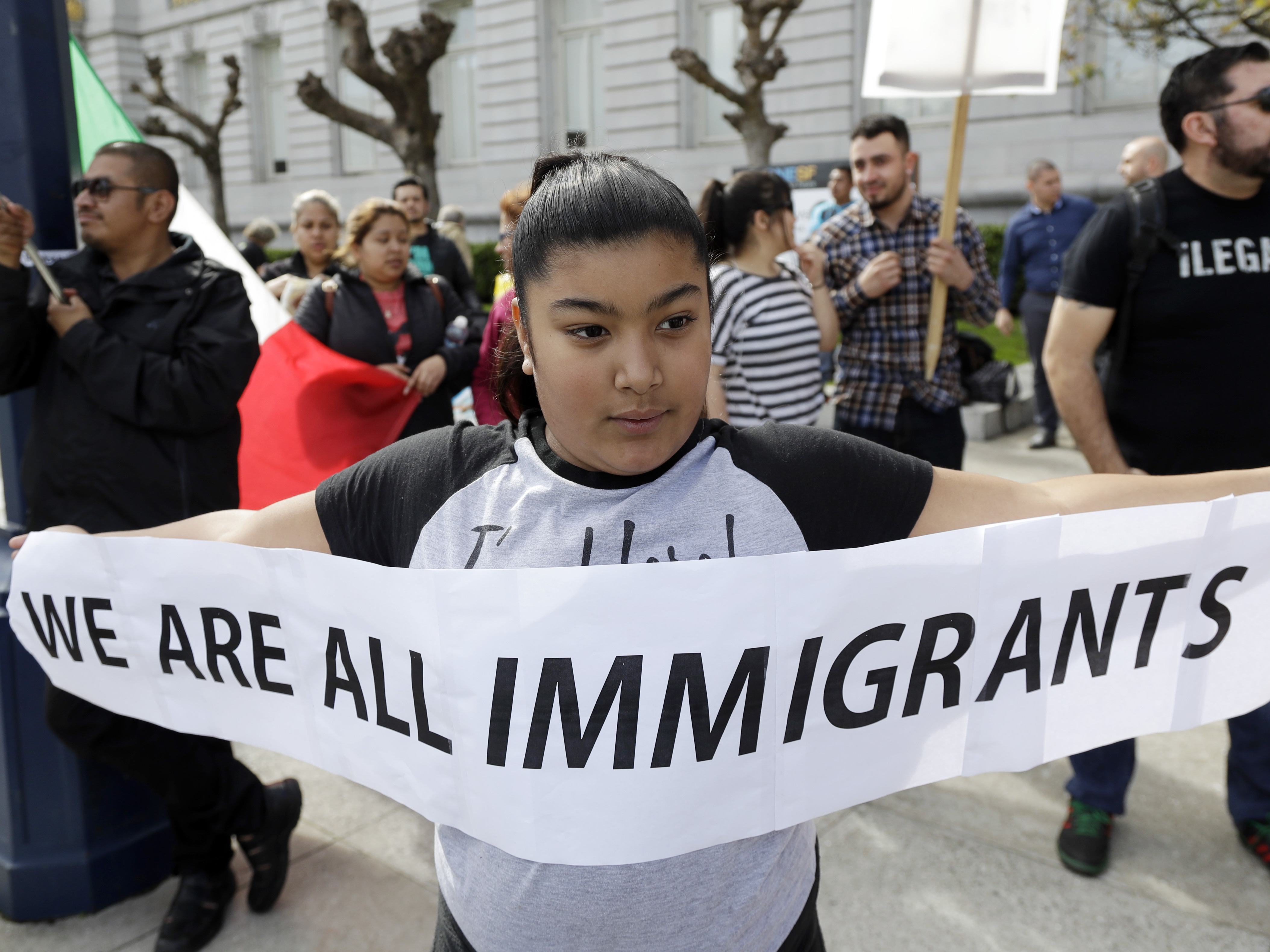 Delilah Gutierrez holds a sign during a protest against President Trump's efforts to crack down on immigration in San Francisco earlier this year