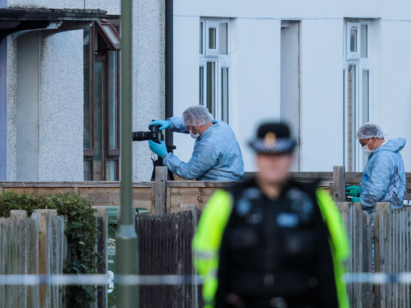 Forensics officers investigate a property in relation to Friday's terror attack in London. The threat level in the United Kingdom was raised to "critical" after the attack, but it was lowered to "severe" on Sunday.