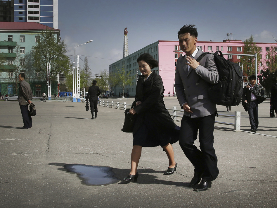 North Koreans walk in downtown Pyongyang on April 18. (Wong Maye-E/AP)