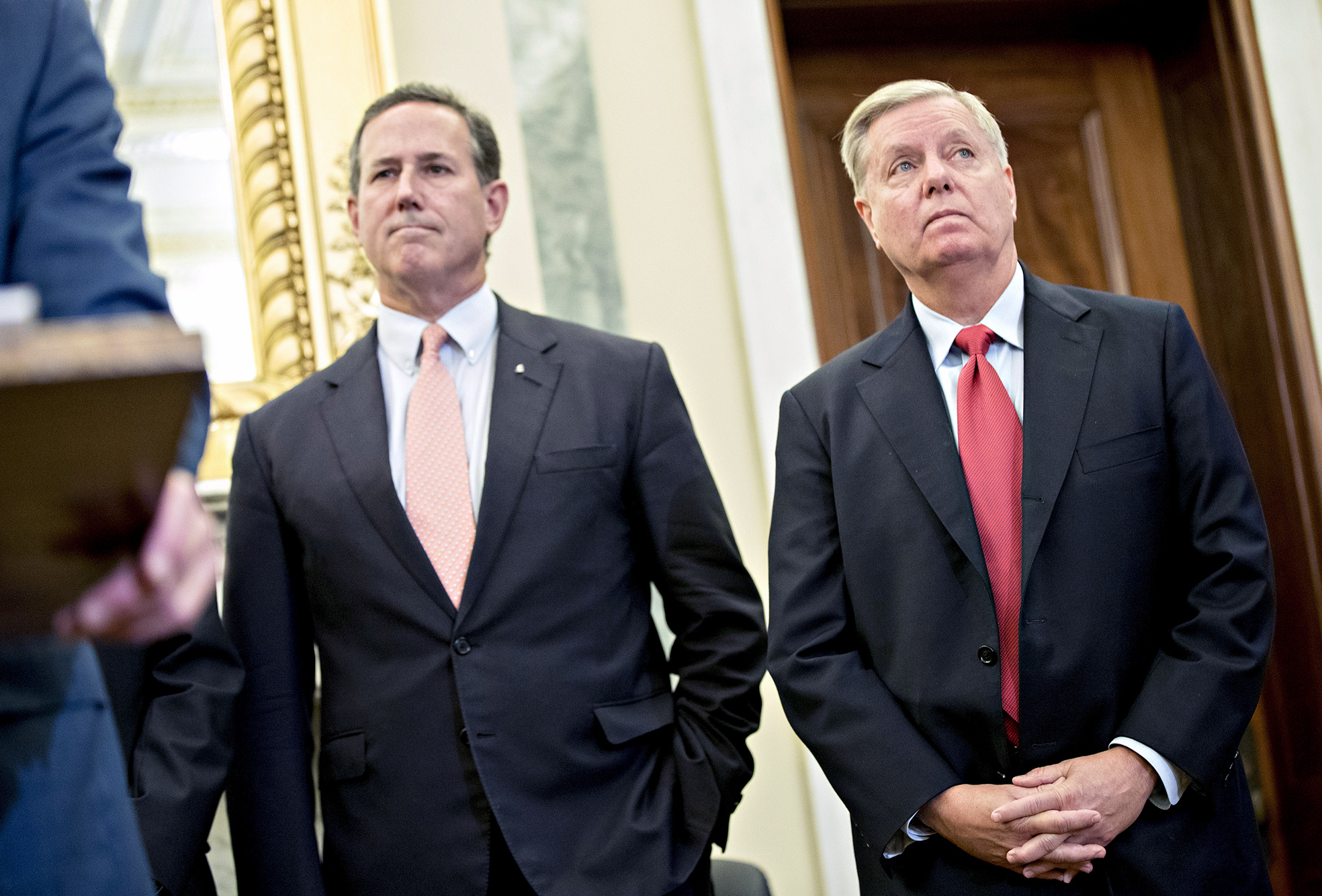 Sen. Lindsey Graham, R-S.C. (right), and Rick Santorum, former senator from Pennsylvania, listen during a health reform news conference on Capitol Hill last week. (Andrew Harrer/Bloomberg/Getty Images)