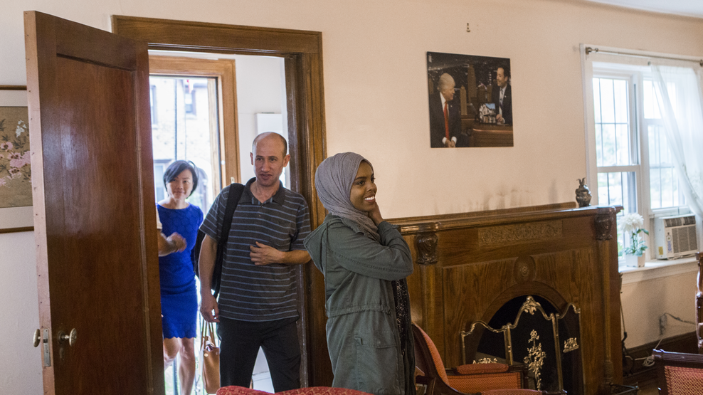 Invited by Oxfam, resettled refugees Eiman Ali, Ghassan Shehadeh and Uyen Nguyen enter President Trump's childhood home in Queens, N.Y.