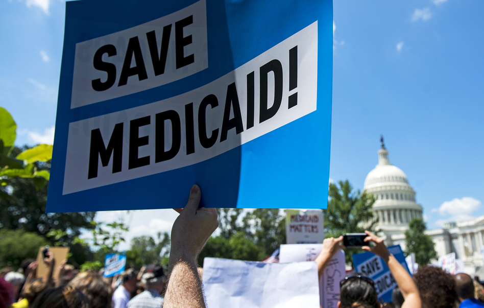 Protesters rally against Medicaid cuts in front of the U.S. Capitol in June. Medicaid is the nation's largest health insurance program, covering 74 million people — more than 1 in 5 Americans. (Bill Clark/CQ Roll Call/Getty Images)