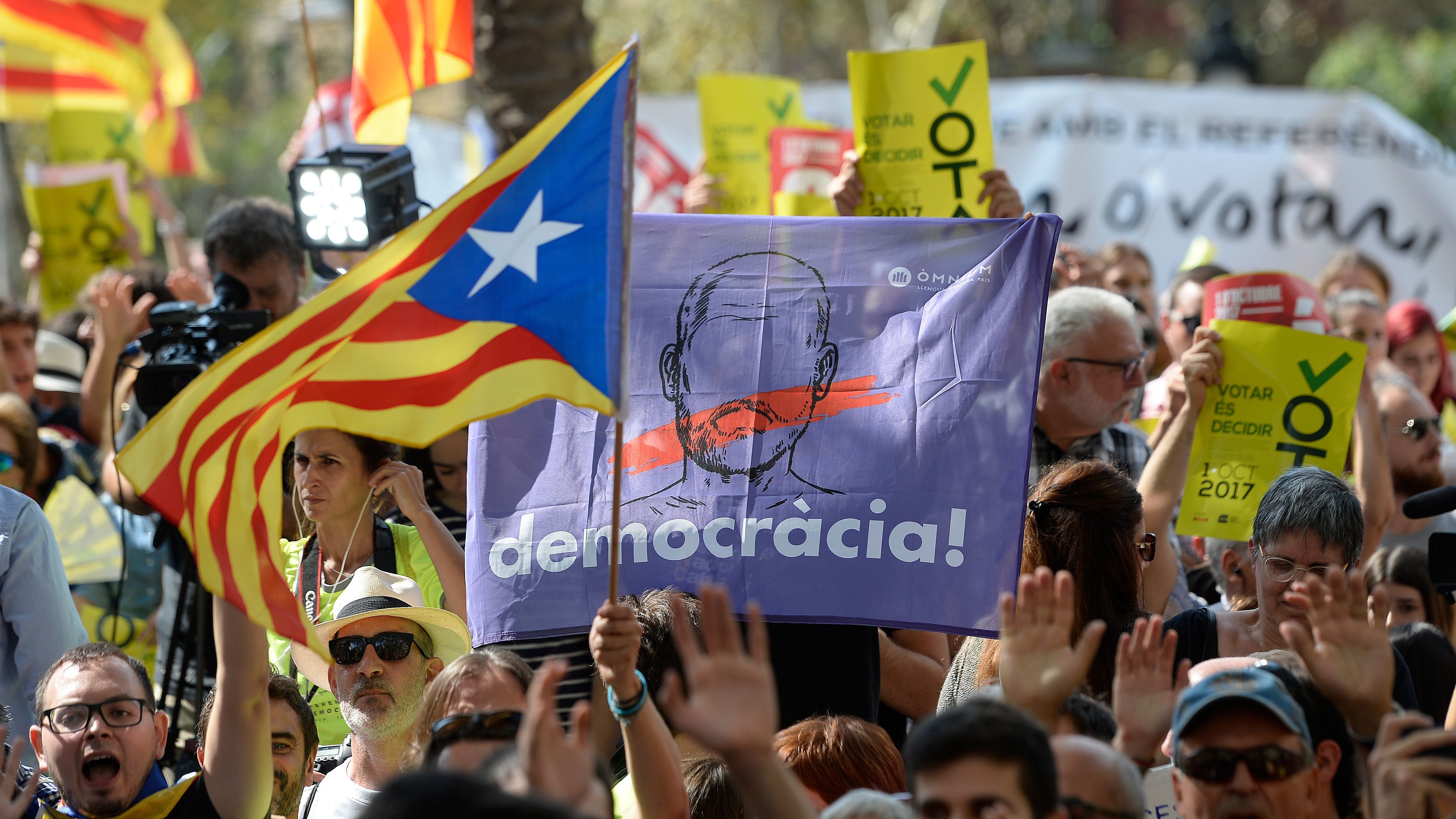 People hold Catalan pro-independence flags outside the high court in Barcelona, Spain, on Thursday. After a daylong protest that lasted well into the night, several thousand independence supporters gathered again in front of the high court in what influential separatist organizations said would be a &quot;permanent mobilization&quot; until detained Catalan officials are freed. (AFP/Getty Images)