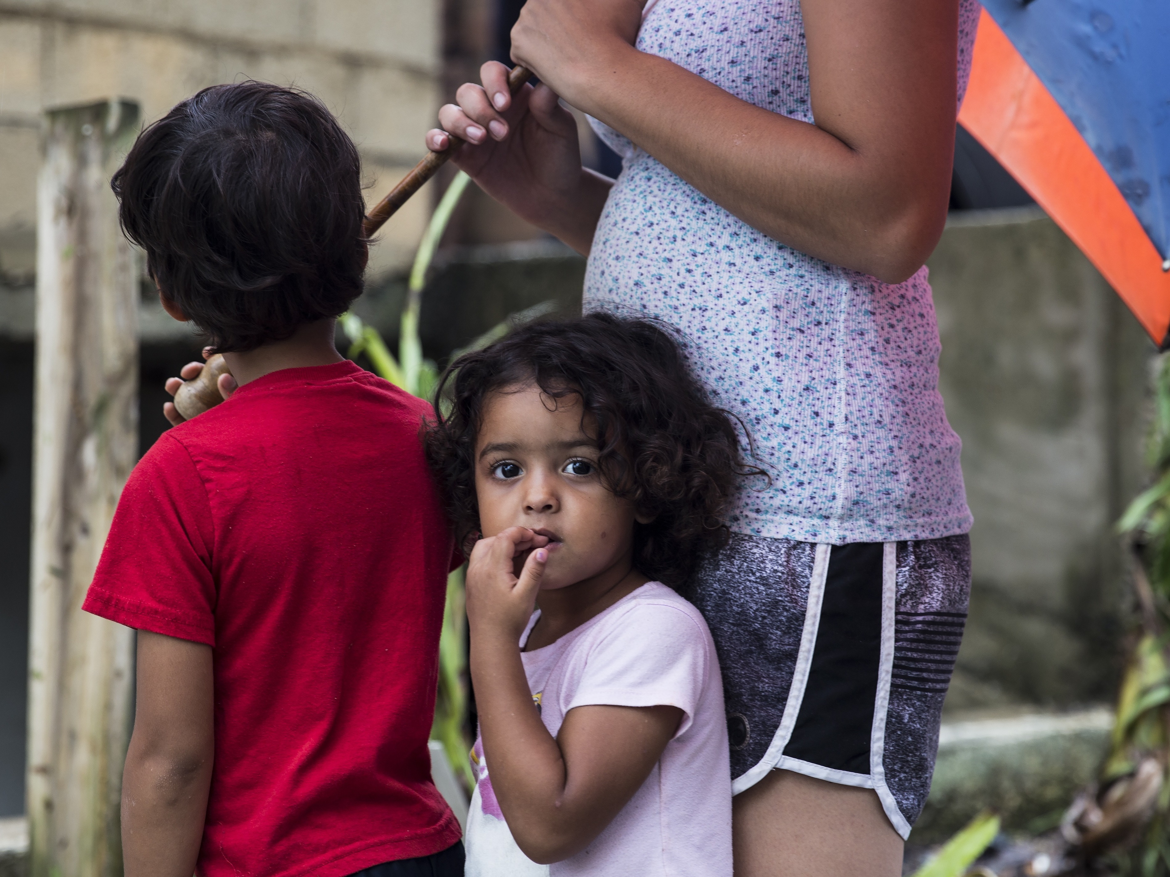 Three-year-old Deyanery Ramirez is in the La Perla neighborhood of San Juan, Puerto Rico, on Thursday. Without cell service on the island, it has been difficult for people to check on their loved ones. (Getty Images)
