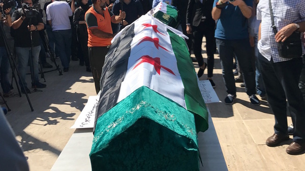The caskets of slain mother and daughter Orouba and Halla Barakat are prepared for the funeral Saturday in Istanbul.