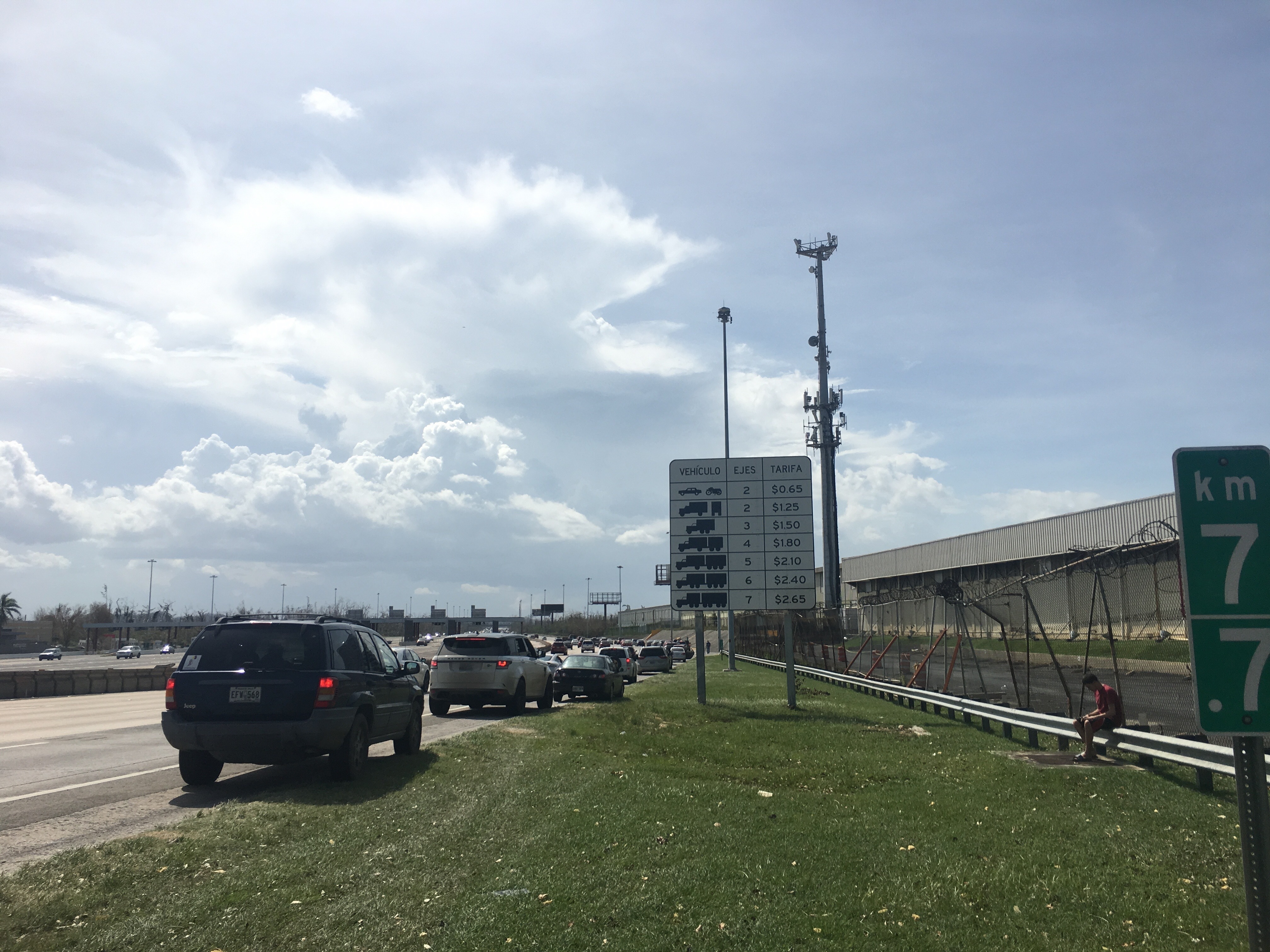 Cars line up along Highway 22, outside of San Juan in Puerto Rico, as drivers try to catch a cell phone signal. (NPR)