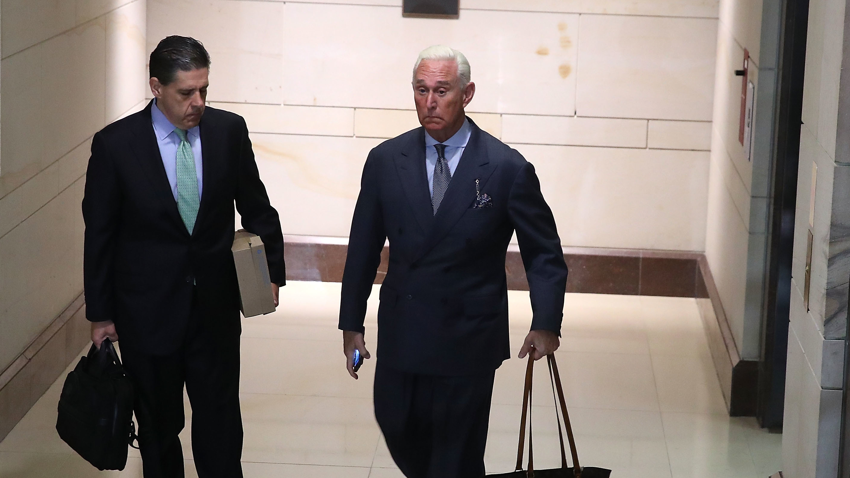 Roger Stone (right), a former adviser to President Trump, arrives to appear before the House Intelligence Committee on Tuesday. Stone flatly denied any accusations of collusion between Russia and the Trump campaign. (Getty Images)