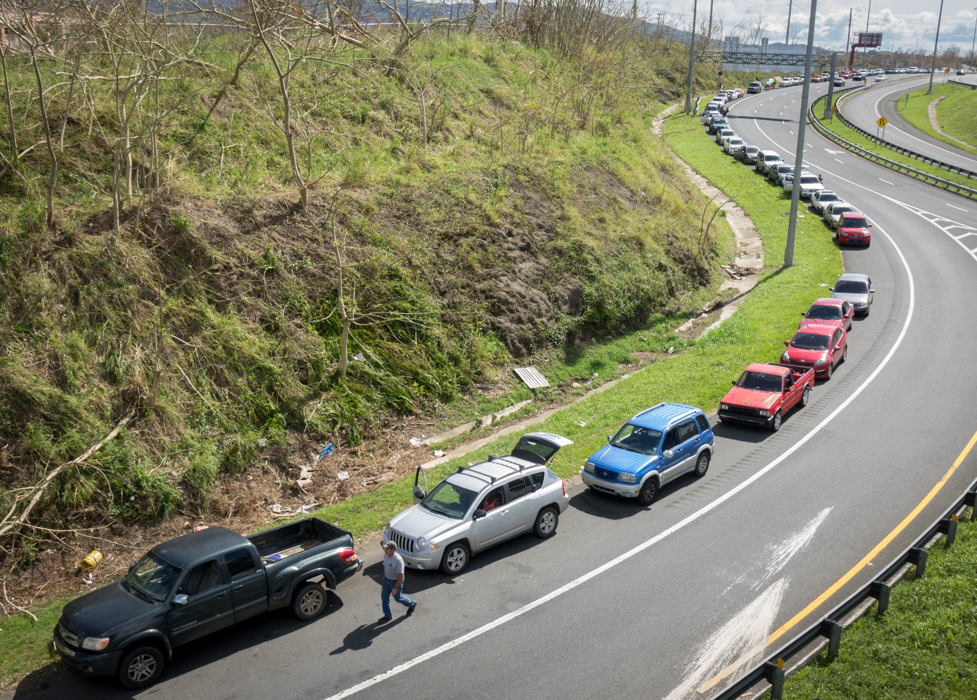 A line of cars stretches for a mile at the Gulf Route 65 gas station in Rio Grande, Puerto Rico, as people wait for a gasoline tanker, scheduled to arrive with fuel sometime Monday. (Angel Valentin for NPR)