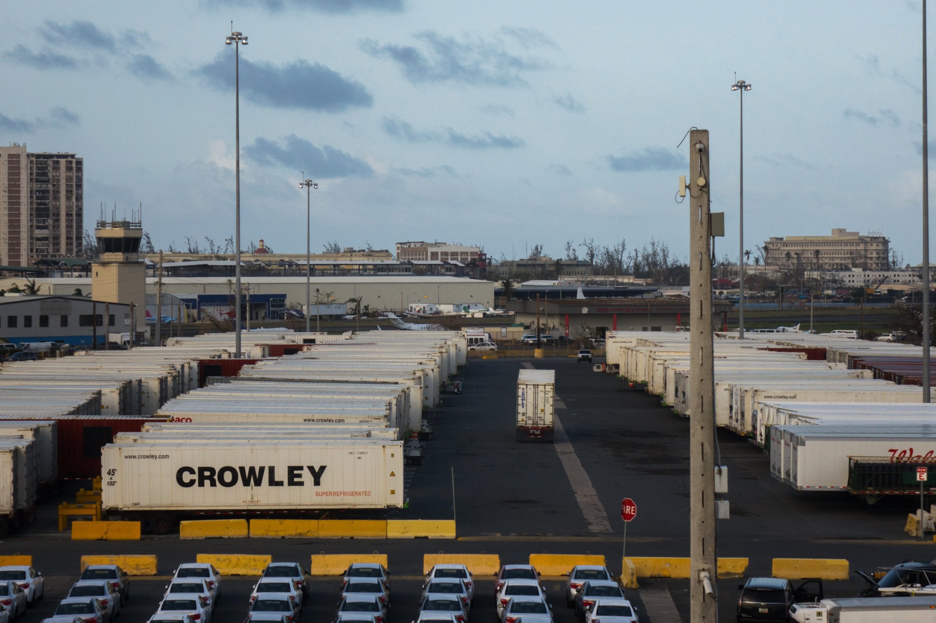 Crowley shipping containers with running refrigeration systems are lined up at in the port of San Juan, Puerto Rico. They've been there for days, goods locked away inside. (Angel Valentin for NPR)