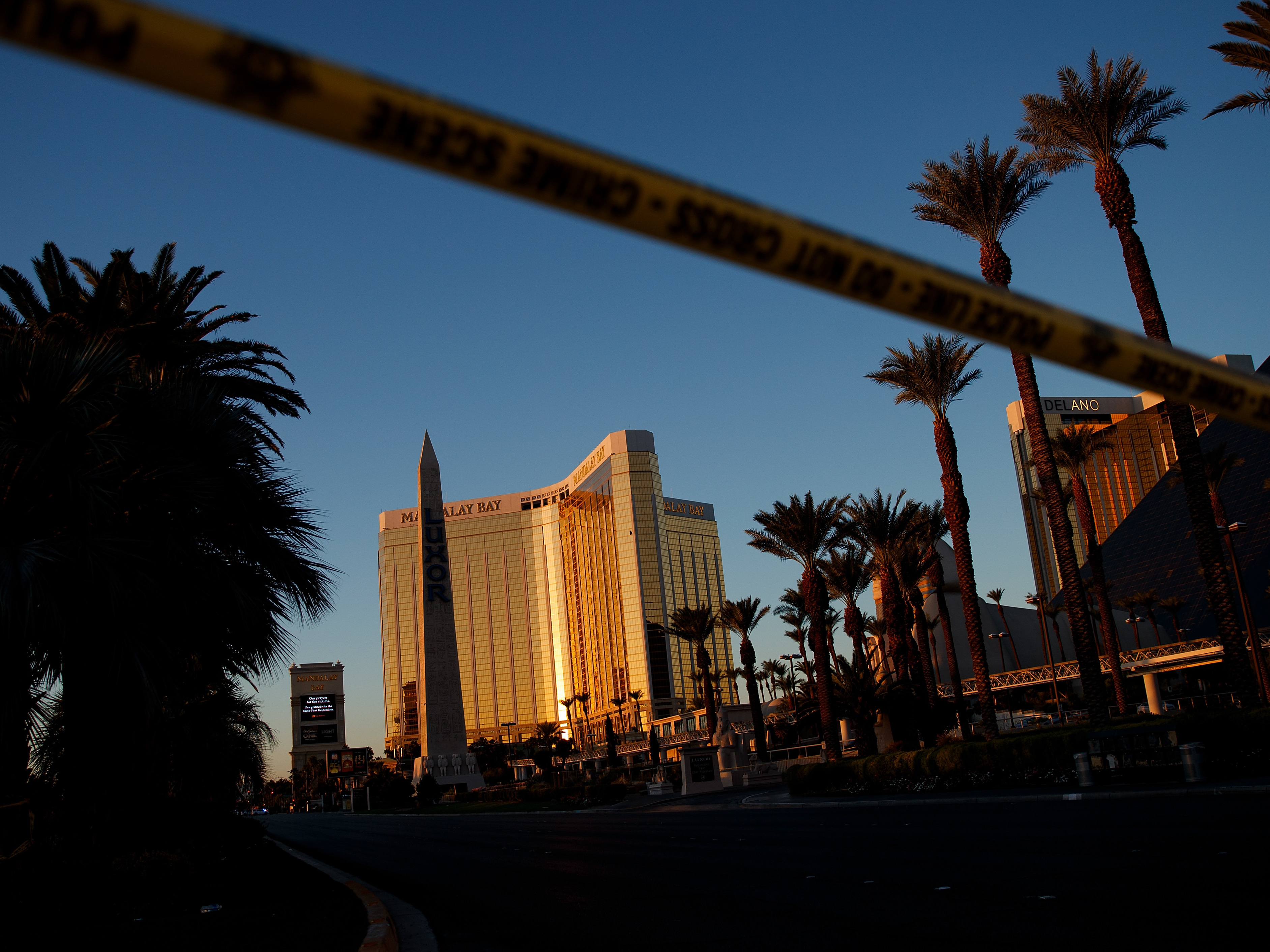 Police tape blocks off part of Las Vegas Blvd. on Tuesday near the scene of a massacre at a country music festival in Las Vegas. Twelve devices known as bump stocks were found in the gunman's room. (Getty Images)