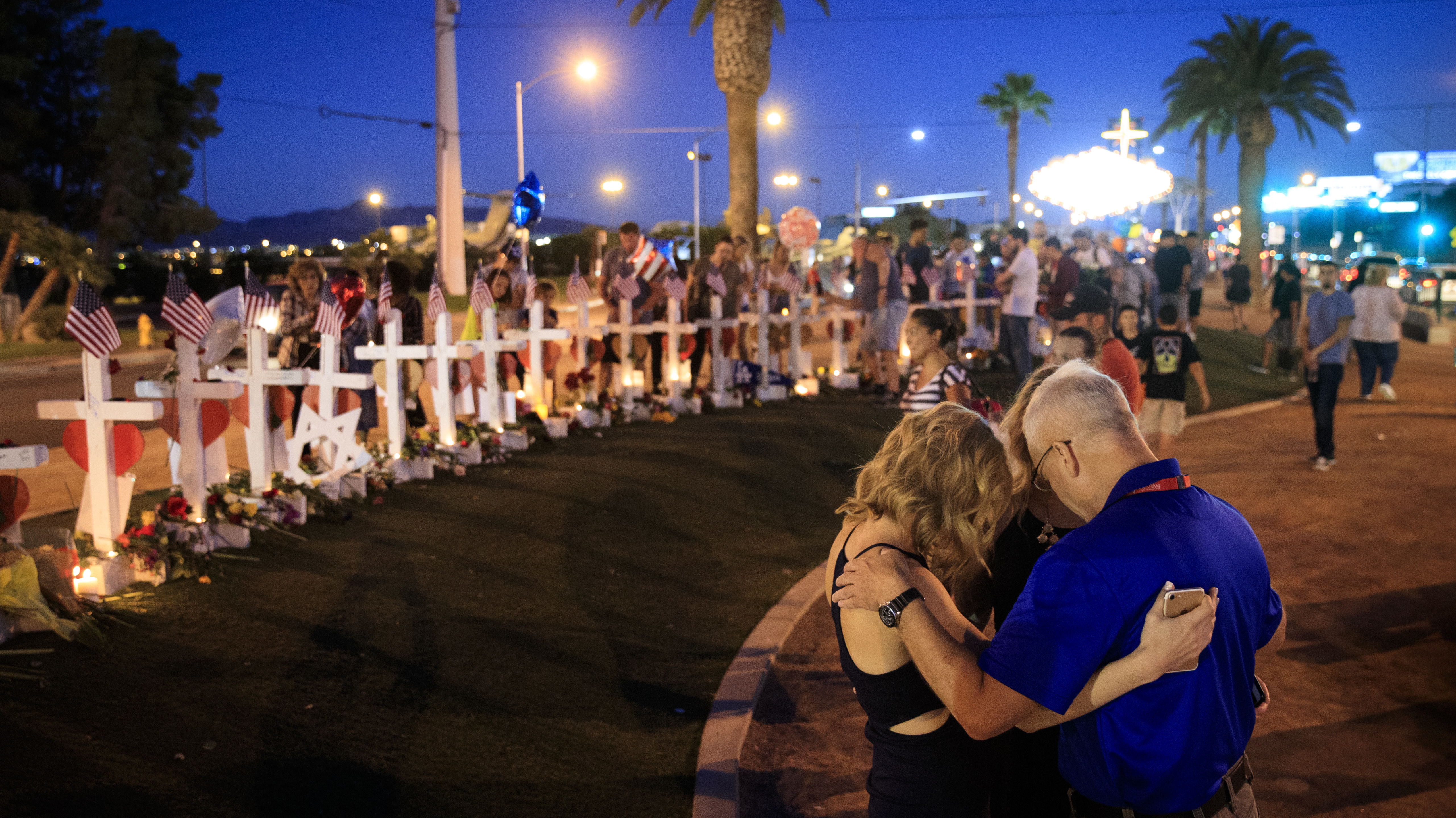 A small group prays at a makeshift memorial for victims of the Las Vegas massacre. (Getty Images)
