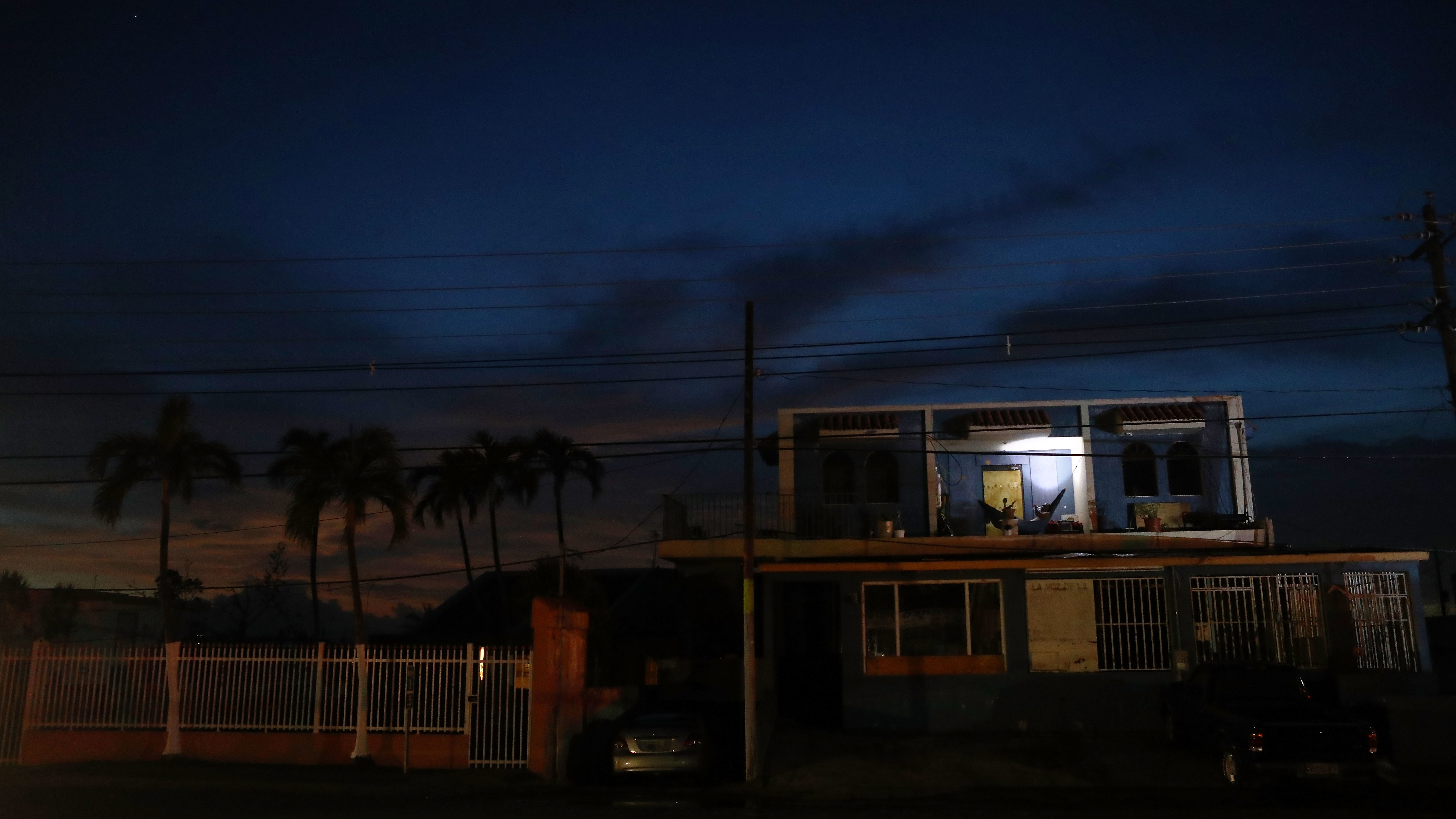A man rests in a hammock, using a battery-operated light, in an area of San Isidro without electricity more than two weeks after Hurricane Maria hit the island of Puerto Rico. (Getty Images)