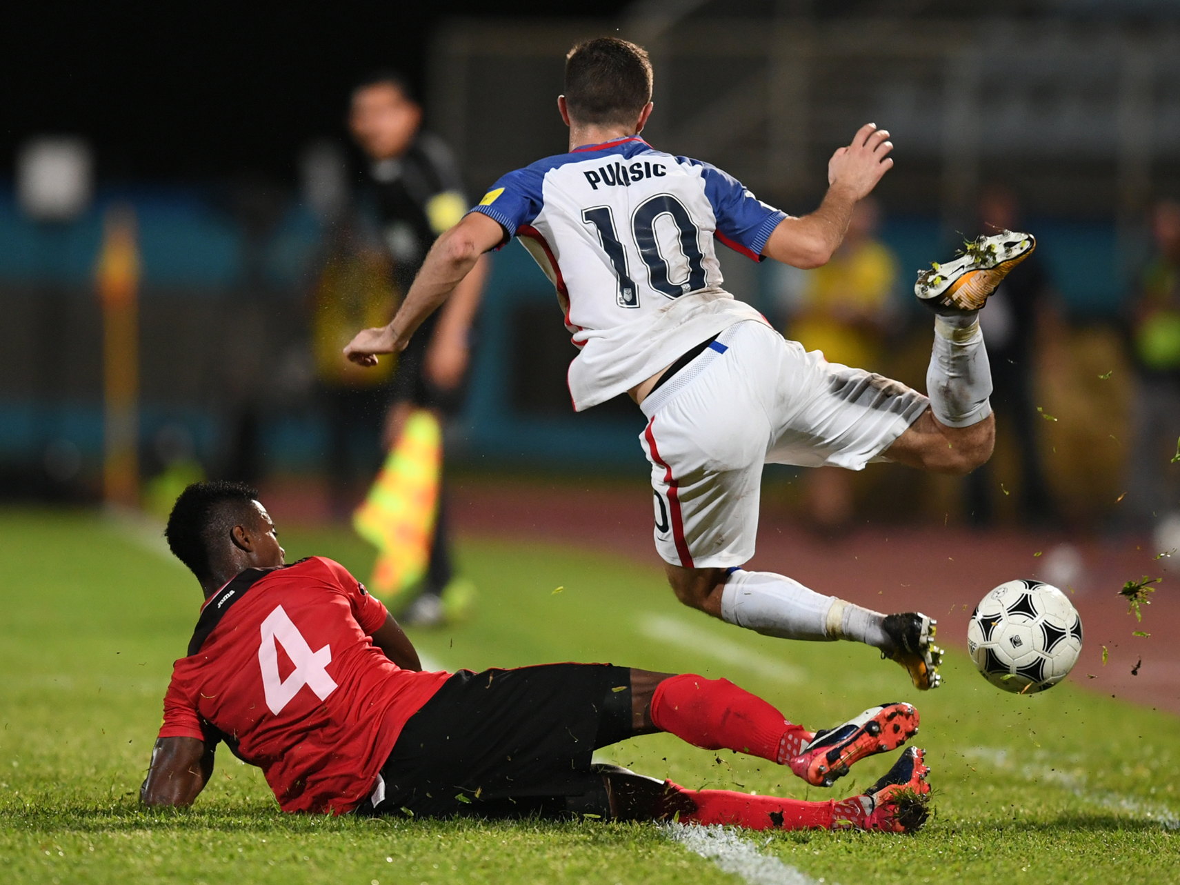 Team USA's Christian Pulisic is defended by Trinidad and Tobago's Kevon Villaroel on Tuesday night during their 2018 World Cup qualifier football match in Couva, Trinidad and Tobago. A loss, combined with other results, means the U.S. team will be staying home next year. (AFP/Getty Images)