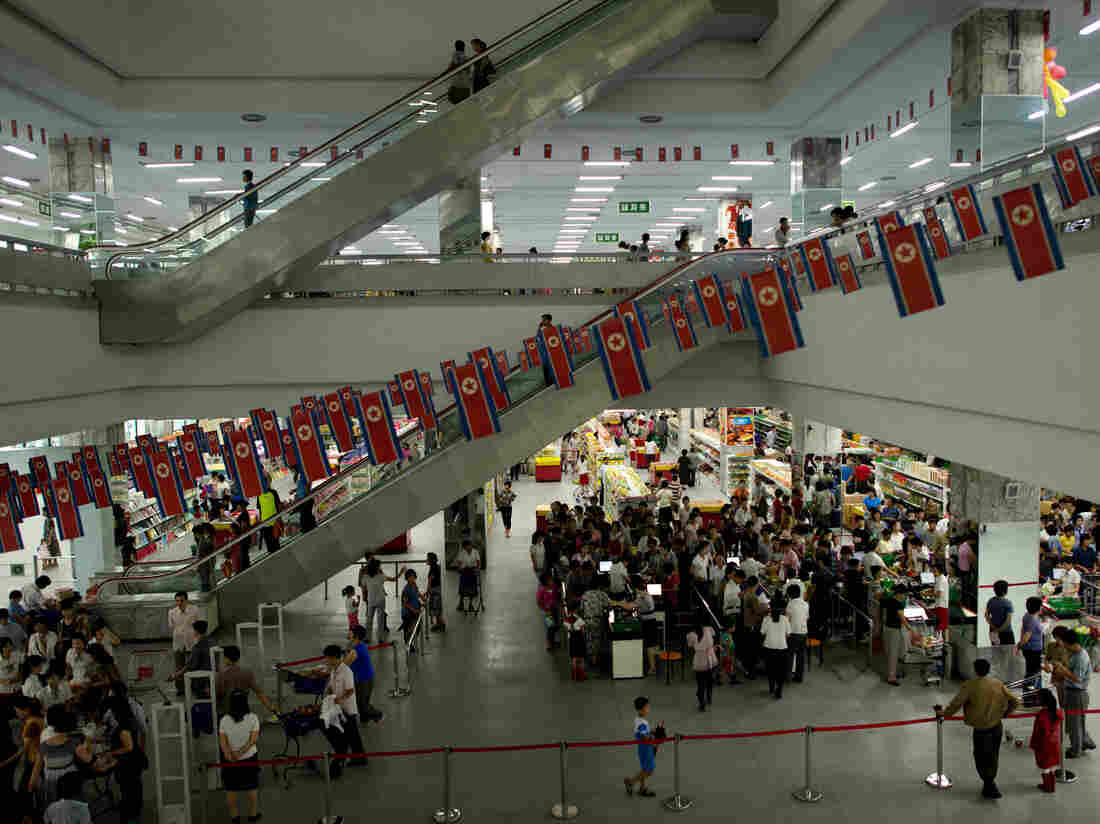 This photo taken on July 28, 2013 shows customers shopping at a supermarket in Pyongyang. Chinese yuan, US dollars, euros and tea bags. Money can come in many forms in North Korea, but as a foreign visitor you'll probably never even see a local banknote, let alone use one. AFP PHOTO / Ed Jones (Photo credit should read Ed Jones/AFP/Getty Images)