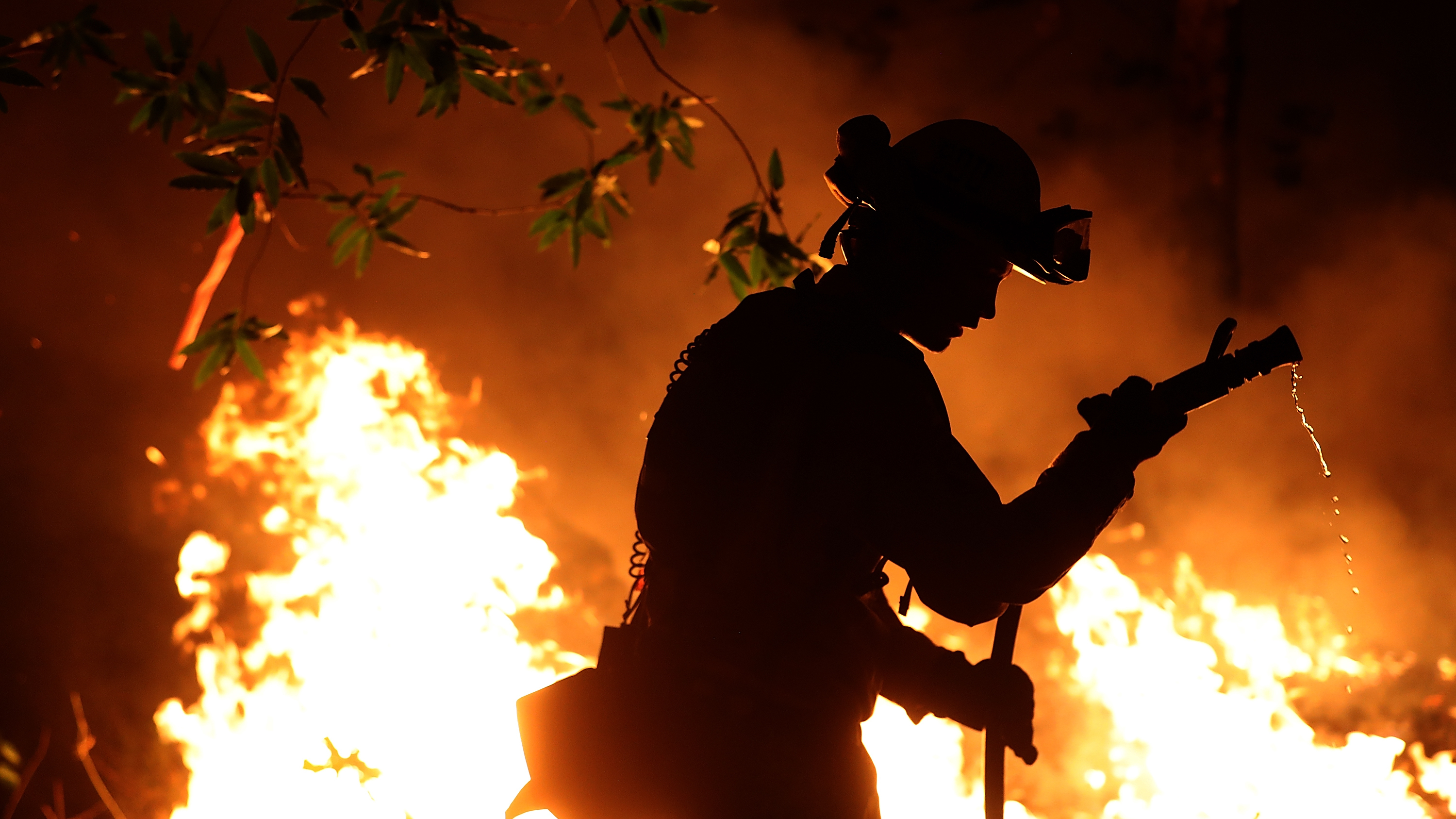 Cal Fire firefighter Trevor Smith battles the Tubbs Fire near Calistoga, Calif., on Thursday. Wildfires in Northern California have killed dozens of people and destroyed thousands of homes and businesses. (Getty Images)
