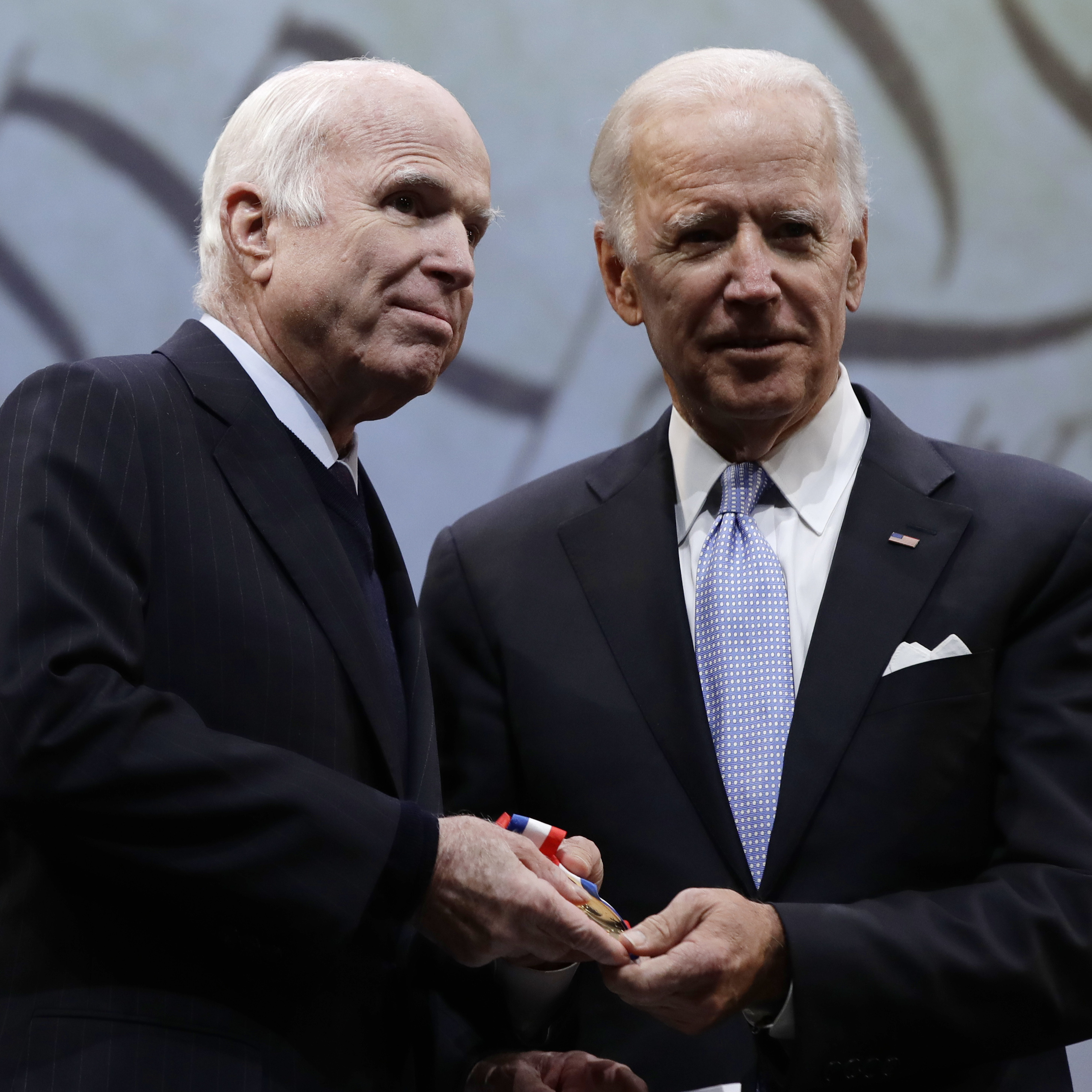 Sen. John McCain, R-Ariz., receives the Liberty Medal from former Vice President Joe Biden, chairman of the National Constitution Center's Board of Trustees, in Philadelphia on Monday.