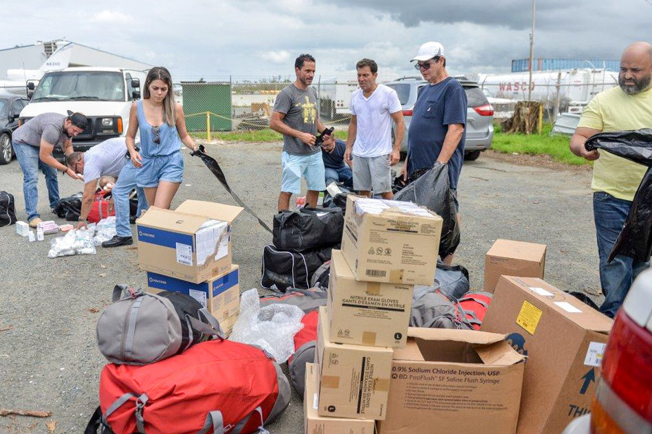 Together, José Ortíz (center left) and Ethan Leder (center right) — without the help of any major agency or aid organization — chartered a plane to Puerto Rico filled with donated medical supplies and get people with acute medical needs out of the island for treatment in the continental U.S. (Courtesy of Willin Rodriguez)