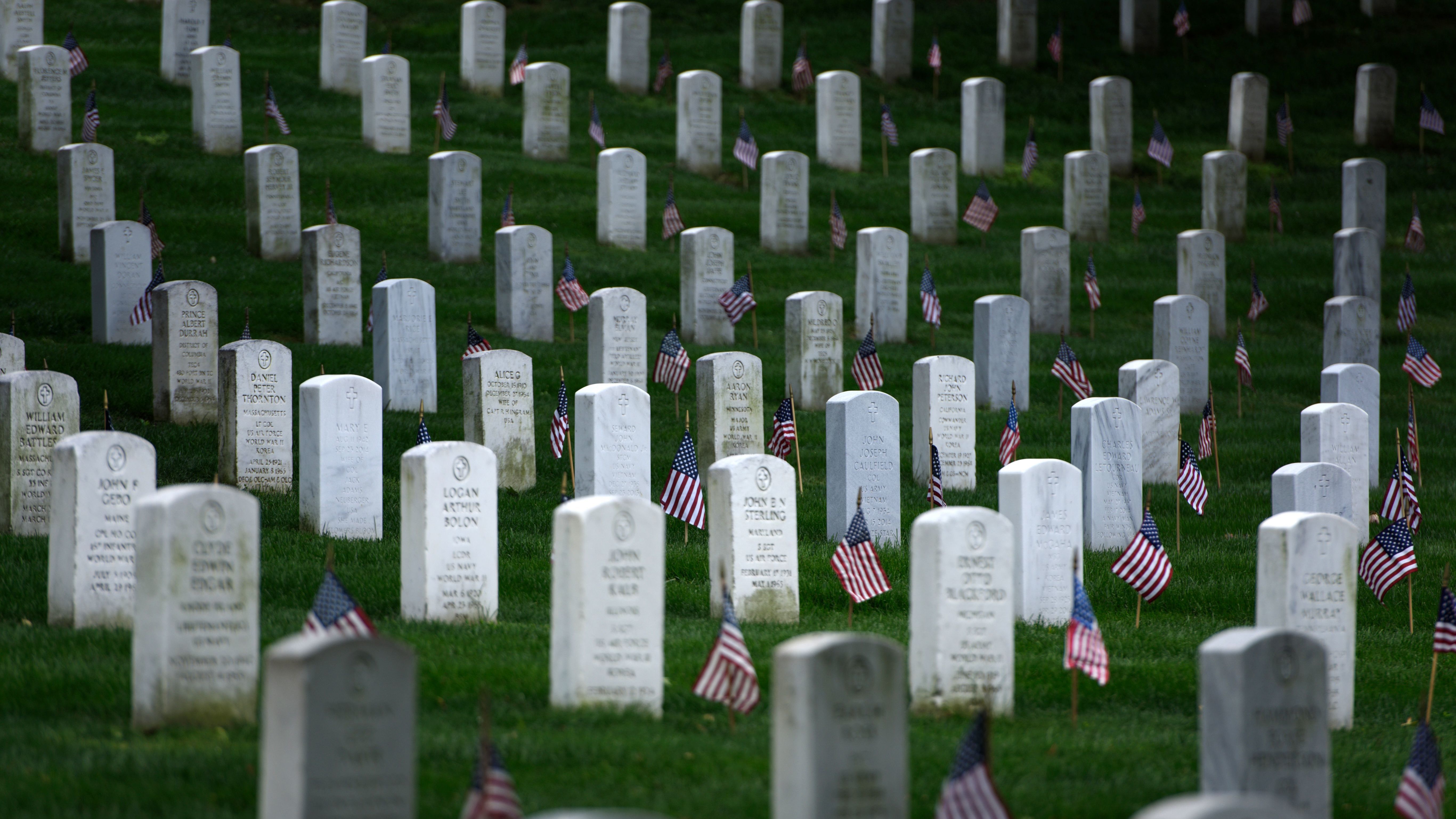 American flags are placed at graves at Arlington National Cemetery in Virginia on May 25, in preparation for Memorial Day.