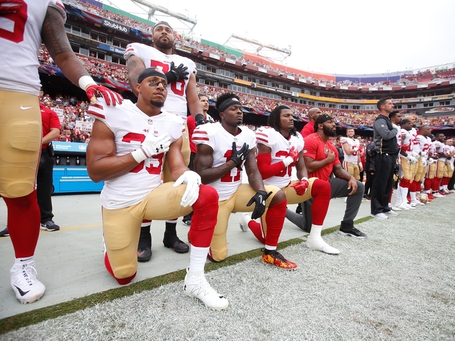 Members of the San Francisco 49ers kneel with teammates during the national anthem before playing the Washington Redskins at FedEx Field in October. (Getty Images)