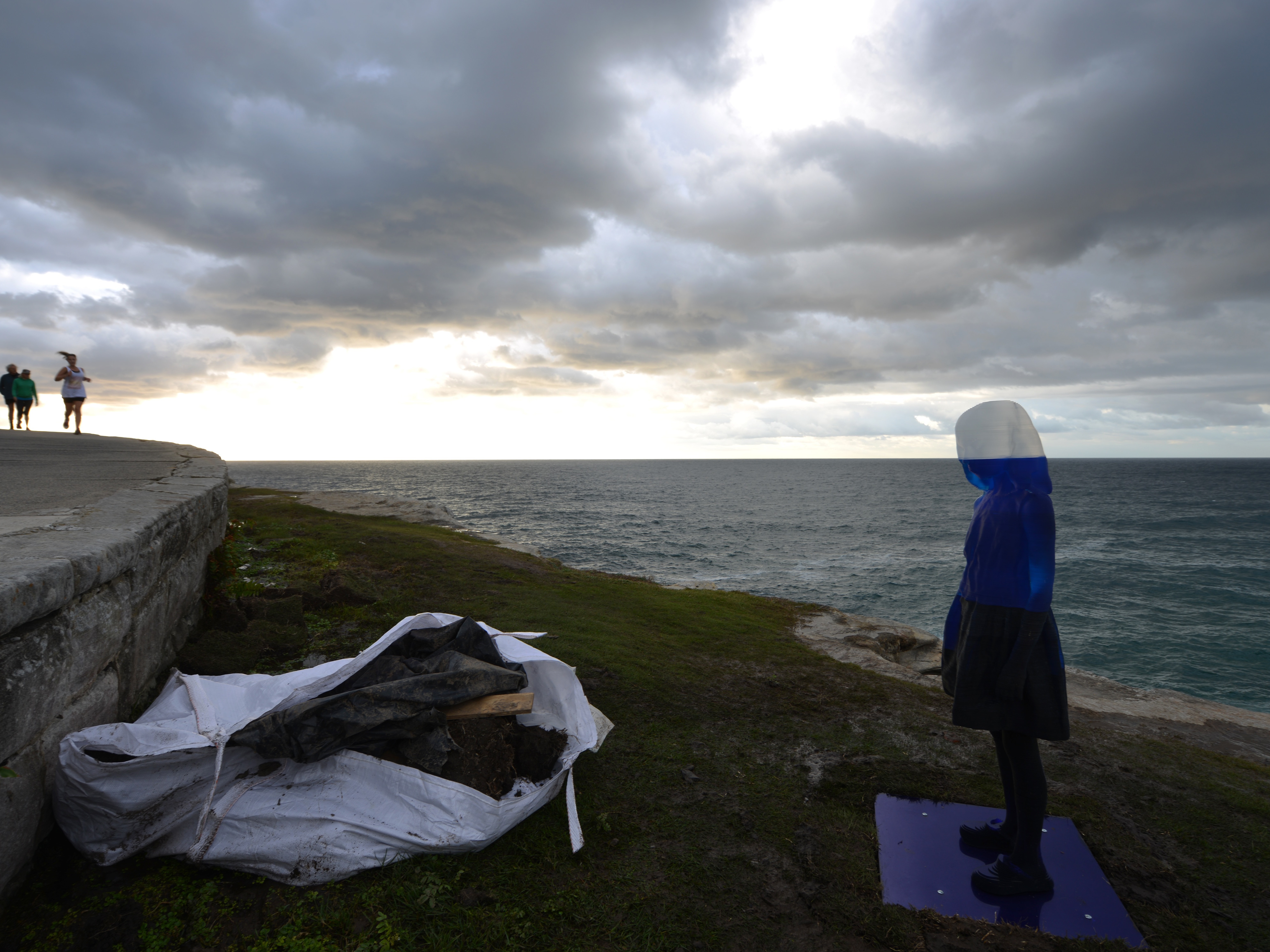 A runner passes a ghostly sculpture on display between Bondi Beach and Tamarama Beach in Sydney. (AFP/Getty Images)