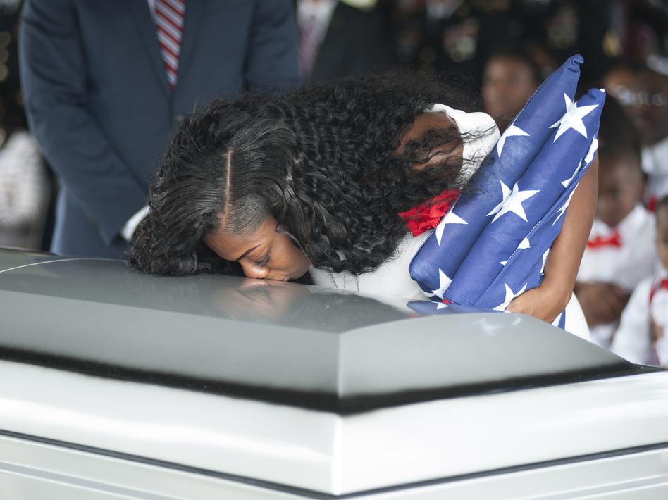 Myeshia Johnson kisses the casket of her husband, Army Sgt. La David Johnson, during his burial service on Saturday in Hollywood, Florida. Sgt. Johnson and three other U.S. soldiers were killed in an ambush in Niger on October 4. (GASTON DE CARDENAS/AFP/Getty Images)