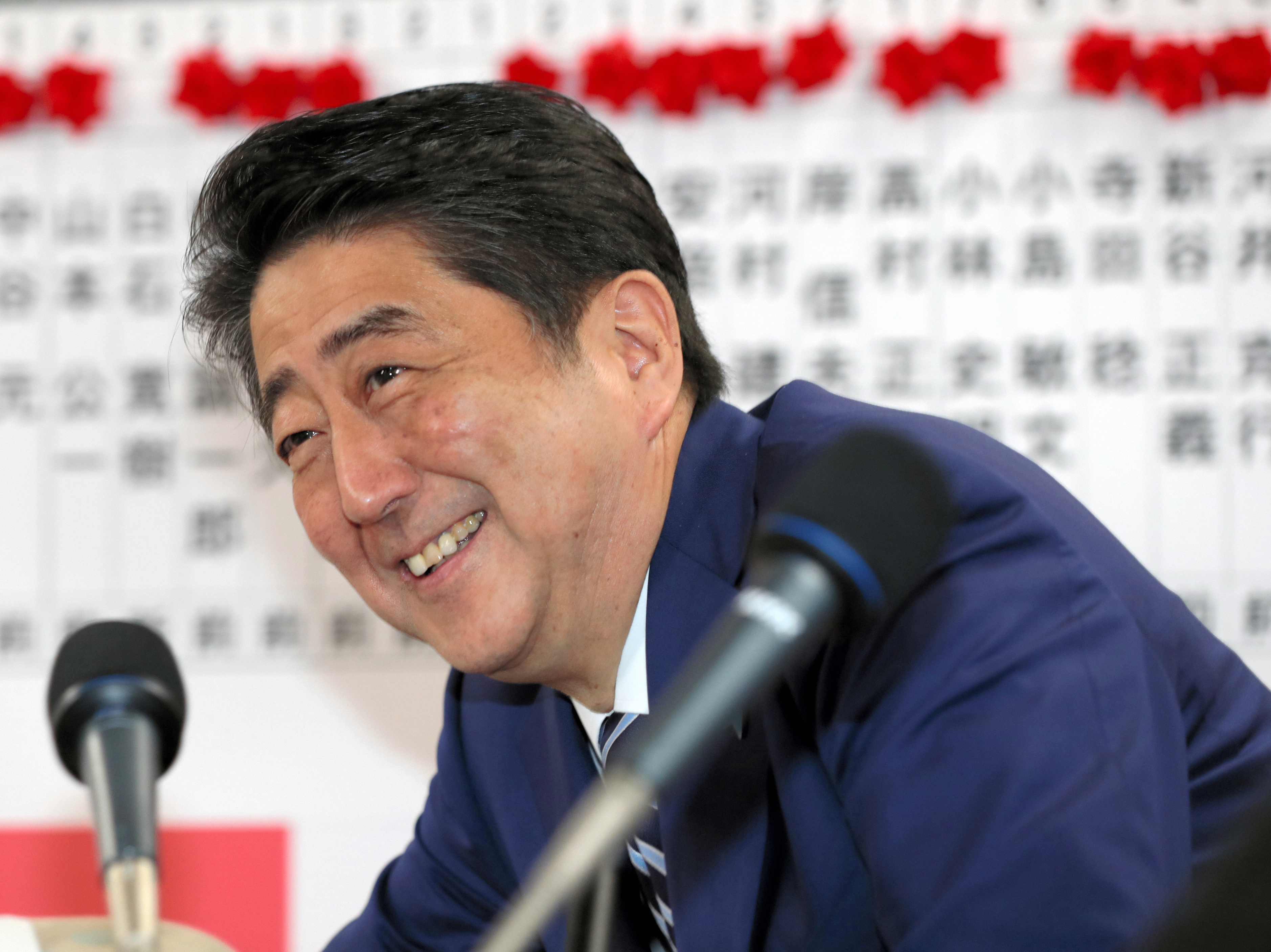 Japanese Prime Minister and ruling party president Shinzo Abe smiles after the general election Sunday in Tokyo in which his ruling party won a clear majority. (The Asahi Shimbun via Getty Images)