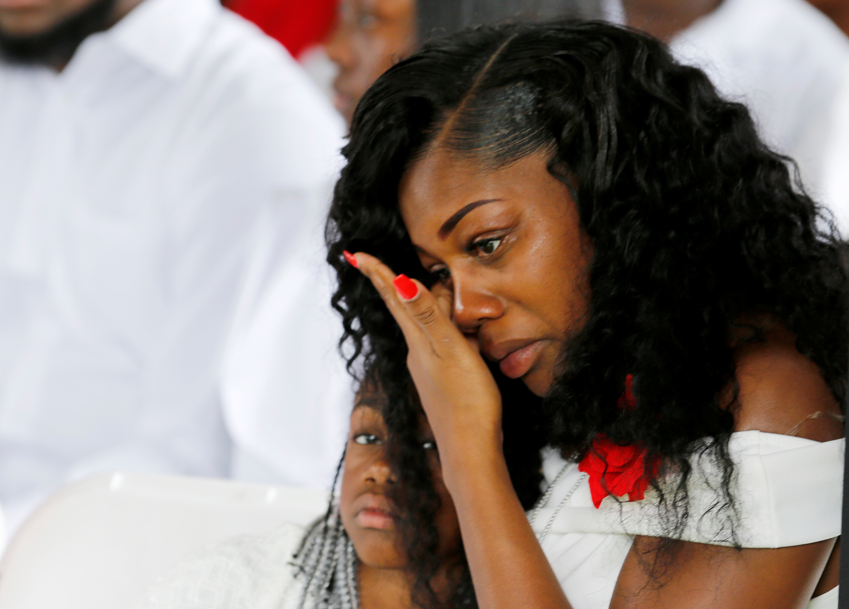 Myeshia Johnson, widow of U.S. Army Sergeant La David Johnson, who was among four special forces soldiers killed in Niger, sits with her daughter, Ah'Leeysa Johnson at a graveside service in Hollywood, Fla., on Oct. 21. (Reuters)