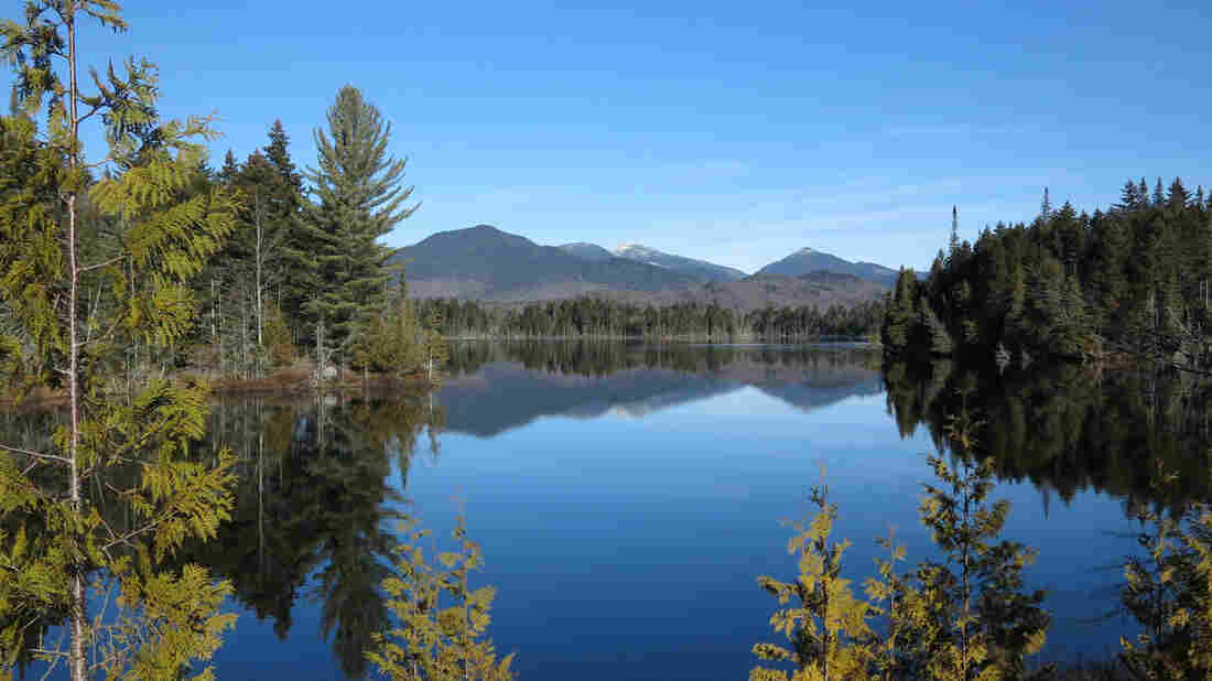 The Adirondack High Peaks, including snow-capped Mount Marcy are reflected in Boreas Pond in North Hudson, N.Y.