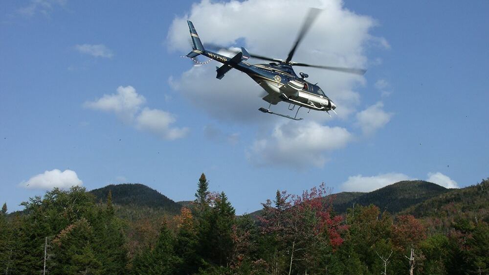 A New York state police helicopter lifts off from a stream valley below Indian Pass, shuttling forest rangers and their equipment in and out of the wilderness.