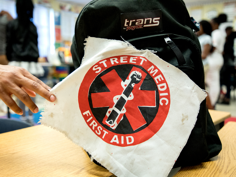 A street medic patch marks a first aid kit at a UMedics workshop in Chicago's Bronzeville neighborhood. The group trains everyday people to care for shooting victims, control a chaotic scene and talk to cops and paramedics. (Andrew Gill/WBEZ)