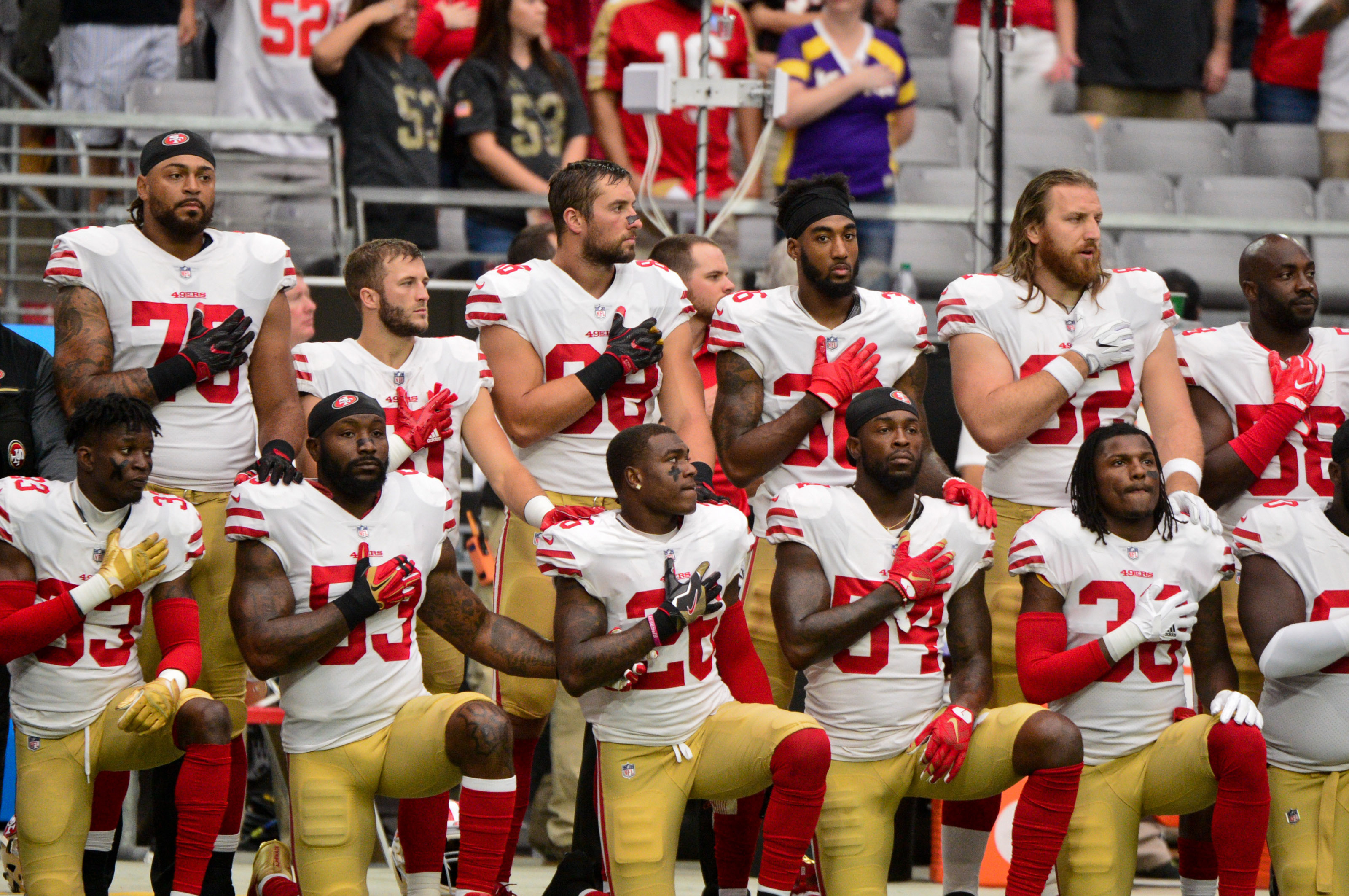 Members of the San Francisco 49ers kneel during the national anthem prior to a game against the Arizona Cardinals at University of Phoenix Stadium on Oct. 1. (Reuters)