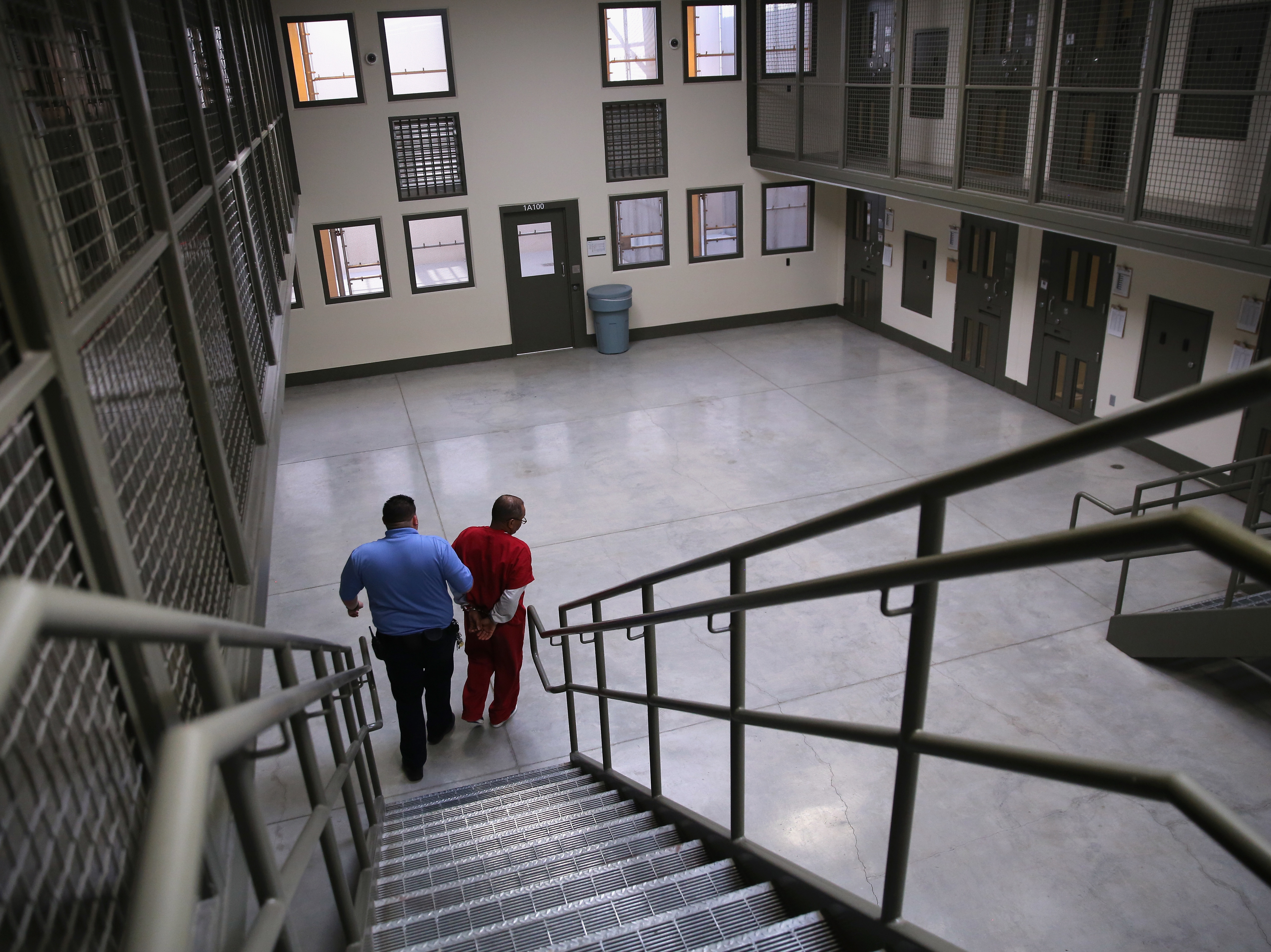 A guard escorts an immigrant detainee at an ICE detention center in Adelanto, Calif., in 2013. Immigration and Customs Enforcement may create new detention facilities around the country to hold record numbers of detainees.