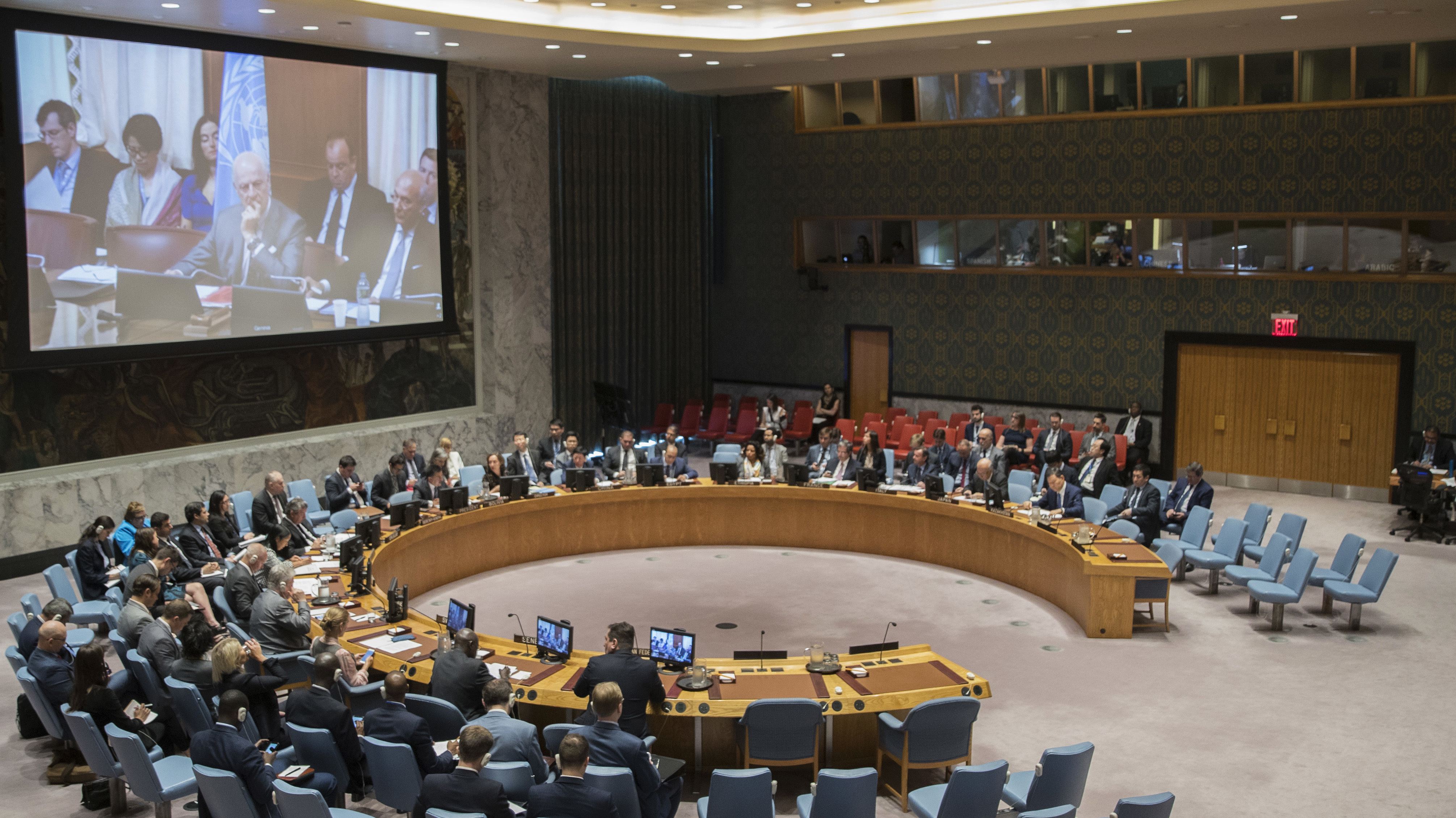 United Nations special envoy to Syria Staffan de Mistura is seen on a video screen as he listens to a Security council meeting on Syria at U.N. headquarters in June about the possible use of sarin gas in an attack that killed more than 90 people.