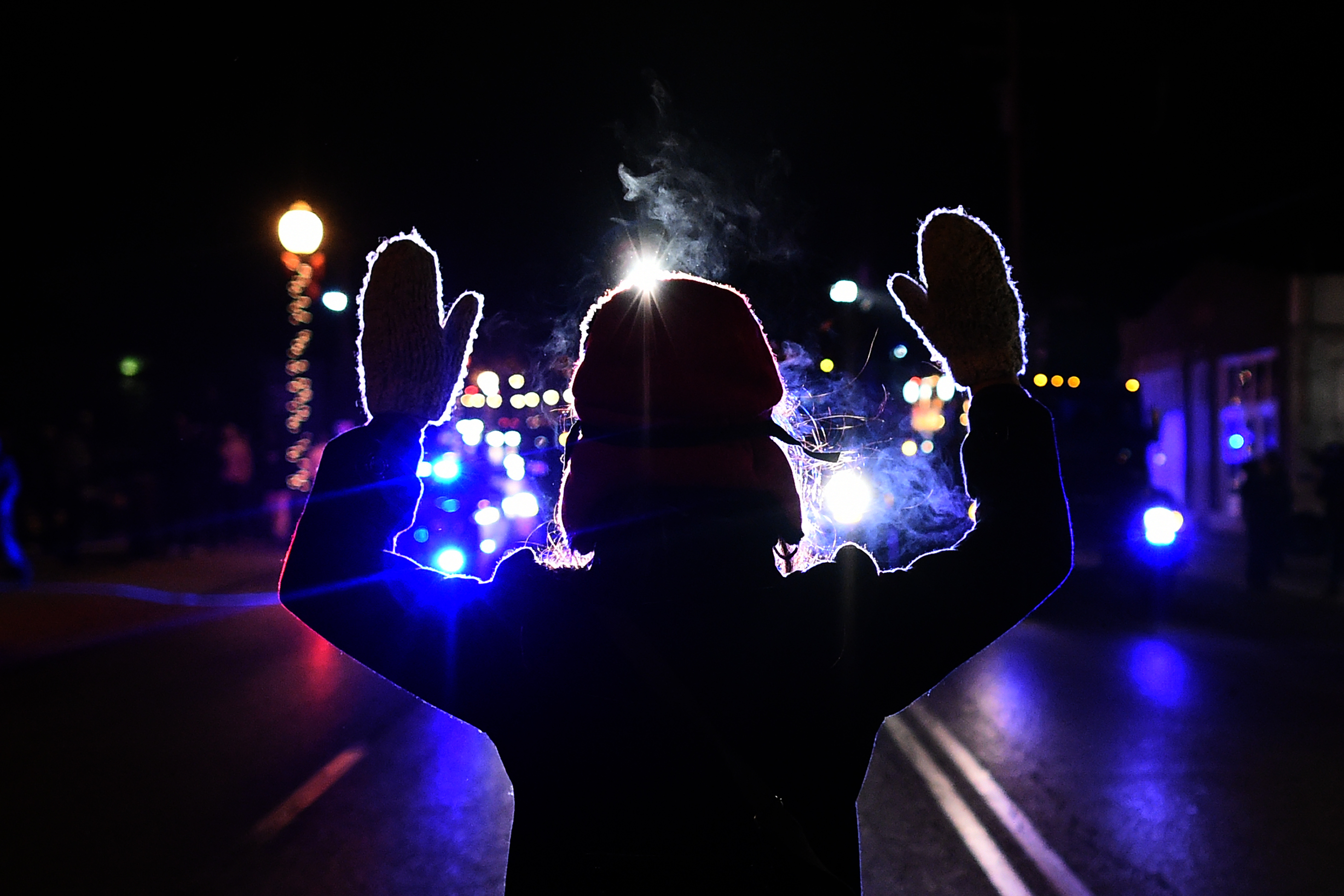 A protester holds her hands up in front of a police car in Ferguson, Mo., on November 25, 2014. (AFP/Getty Images)