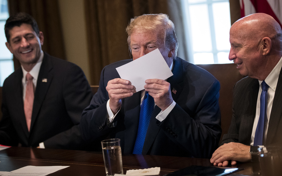 President Trump holds a sample of the Republicans' proposed postcard-size tax return. (Drew Angerer/Getty Images)