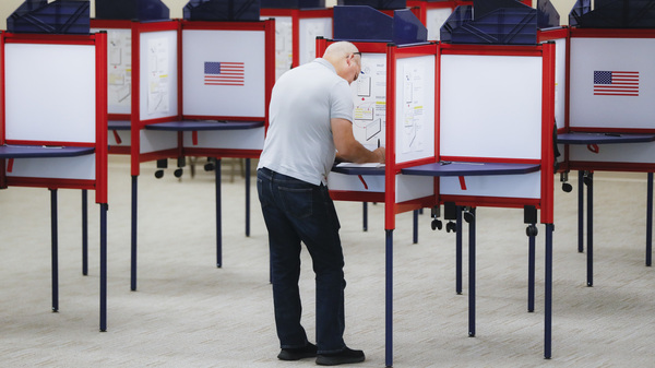 A voter fills out a ballot on the first day of early voting at the Hamilton County Board of Elections in Cincinnati last month.