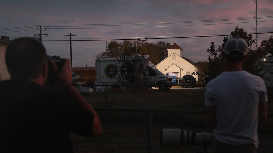Newspaper photographers look on as the sun rises over the First Baptist Church in Sutherland Springs, Texas, the site of a mass shooting during a Sunday service. (Scott Olson/Getty Images)