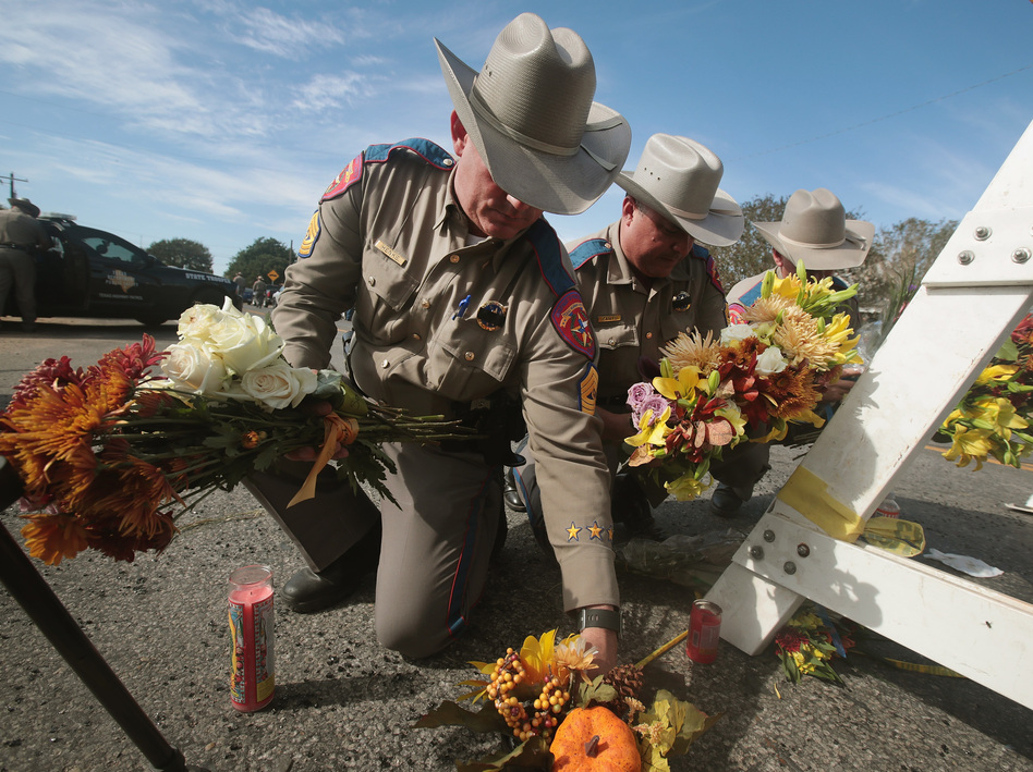 Police move flowers placed at a barricade near the First Baptist Church of Sutherland Springs on Monday in Sutherland Springs, Texas. (Scott Olson/Getty Images)