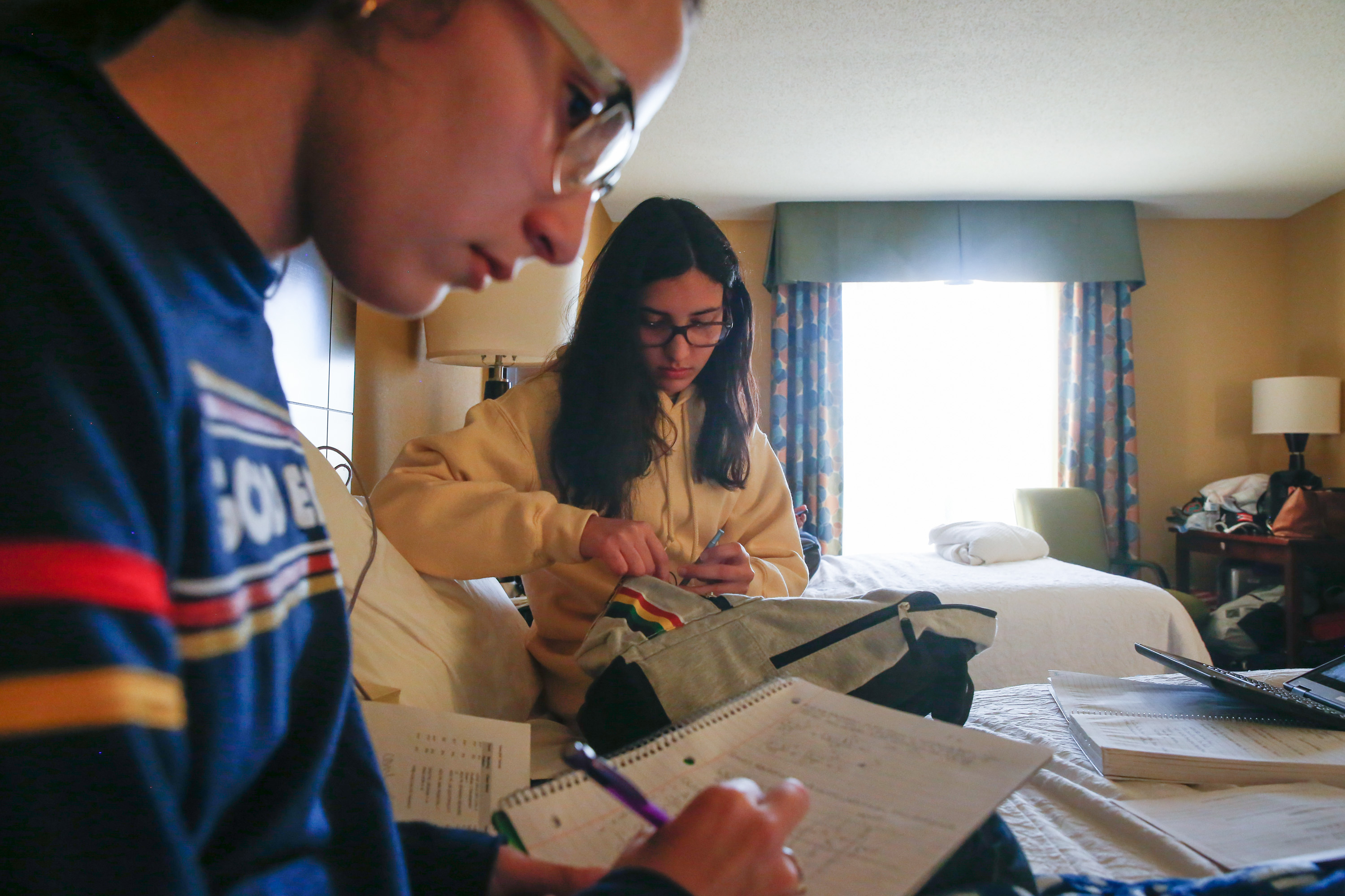 'A New Reality': Students And Teachers From Puerto Rico Start Over In Florida 2 The Roldán sisters do their homework on the bed in the hotel room they share with their mom and stepdad.