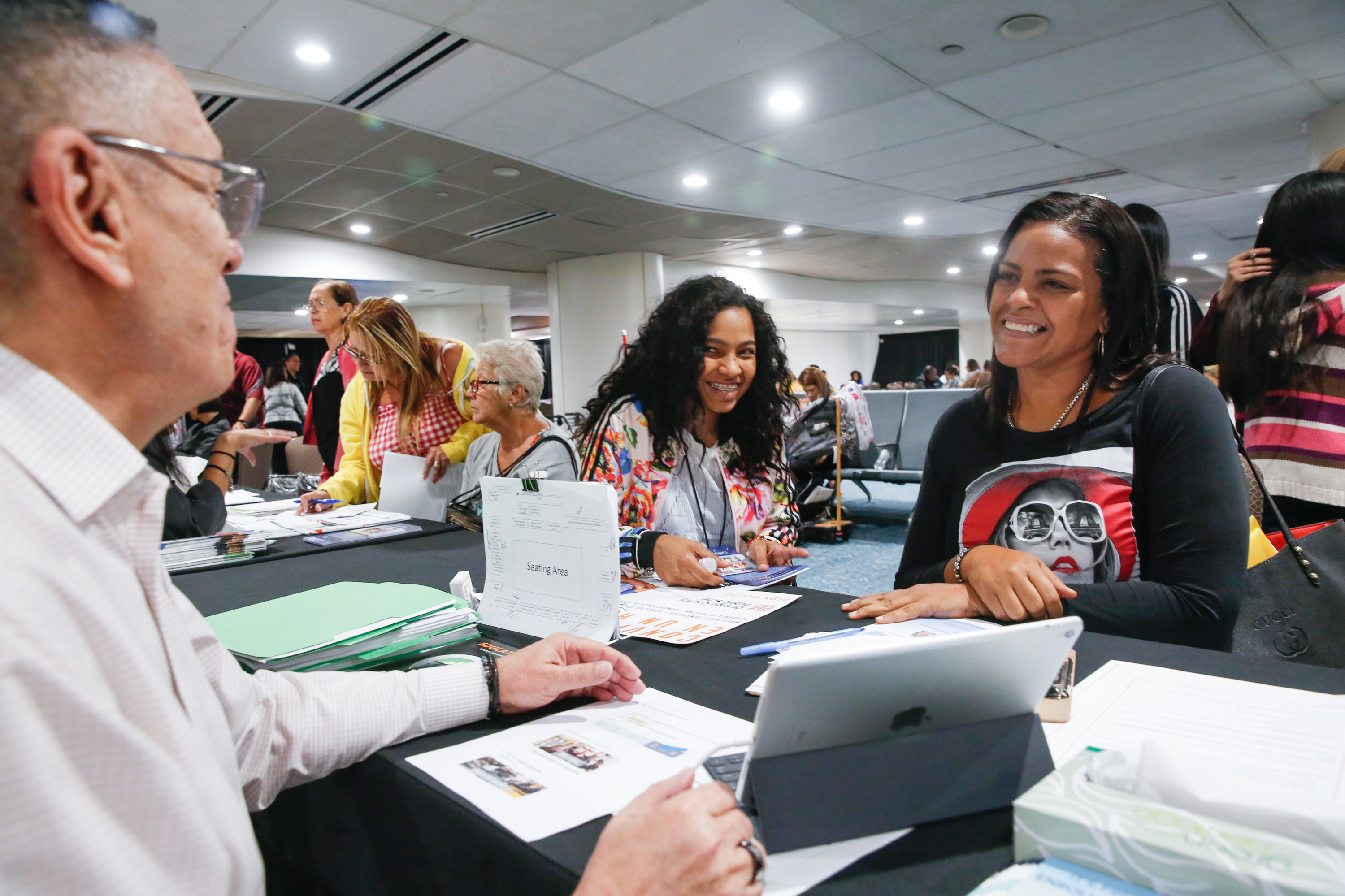 'A New Reality': Students And Teachers From Puerto Rico Start Over In Florida 5 Conchita Santiago, a principal in Puerto Rico, speaks with Javier Melendez, director of human resources at Orange County Public Schools, at the welcome center for Puerto Ricans at the Orlando airport.