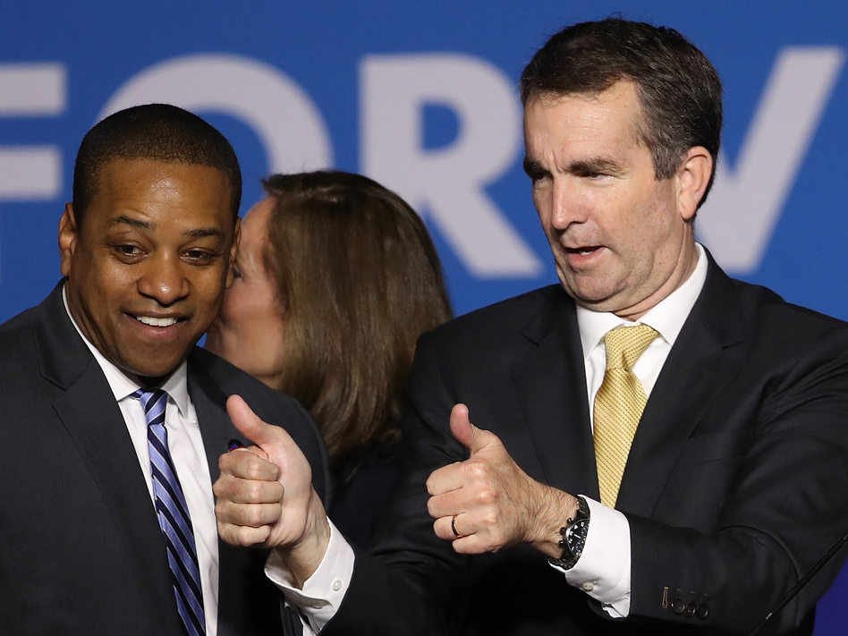 Virginia Gov.-elect Ralph Northam (right) and Lt. Gov.-elect Justin Fairfax greet supporters at an election night rally Tuesday after the Democrats' victory. (Win McNamee/Getty Images)