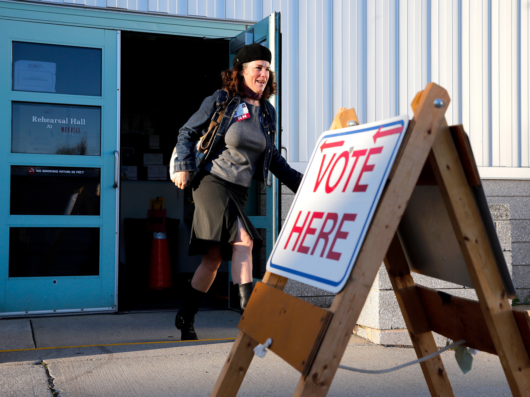 Rosemary Warnock, a registered nurse at Maine Health, exits the Merrill Auditorium voting station in Portland, Maine, early Tuesday. She said she was motivated to vote for Medicaid expansion. (Press Herald via Getty Images)