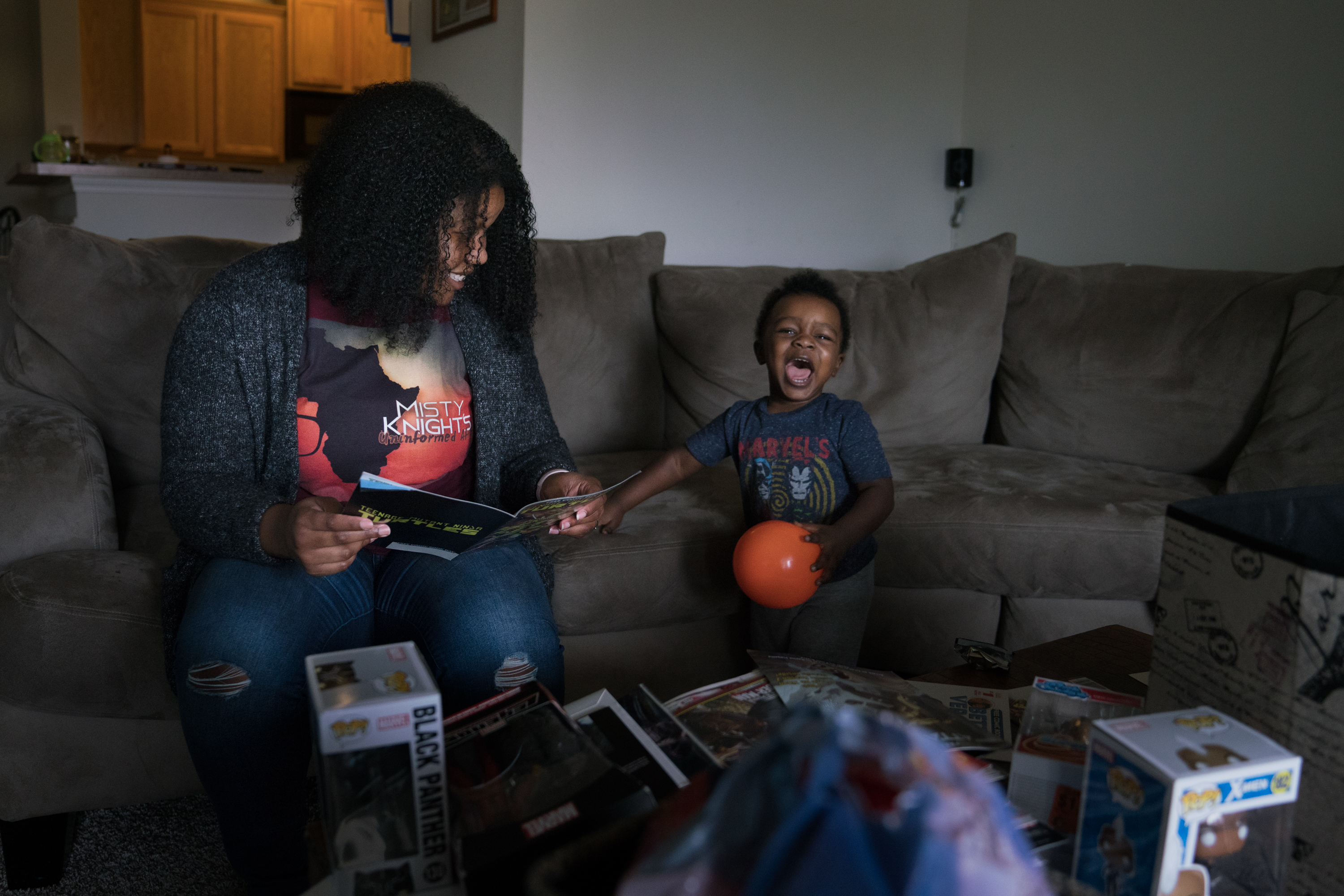 A Lifetime Of Finding Peace, Purpose And Voice In The Pages Of Comics 1 Stephanie Williams and her son Micah, 2, sit on the sofa looking at comic books in their living room in Charlotte, N.C.