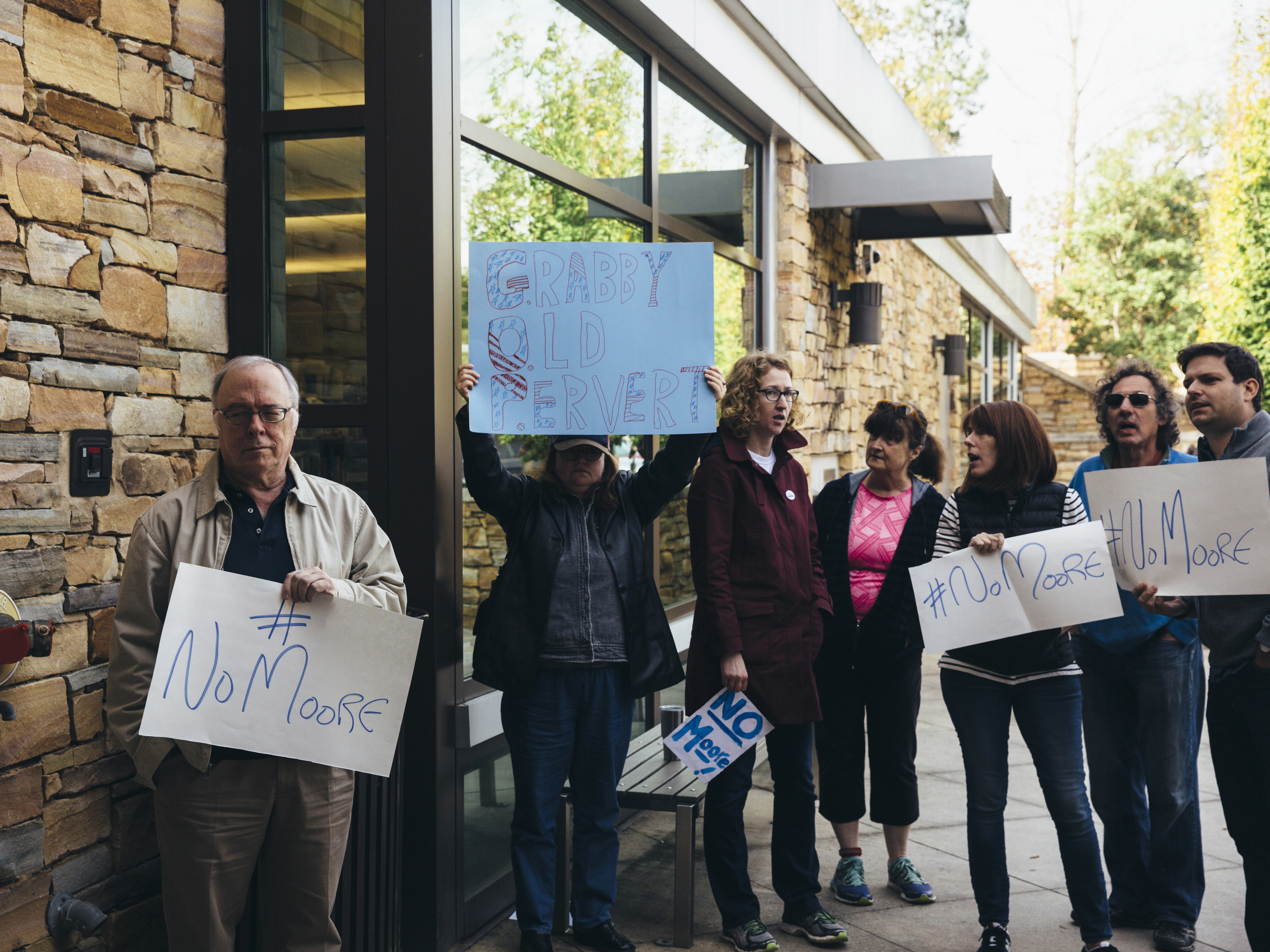 Protesters gather outside as Roy Moore, Republican candidate for U.S. Senate, appears at a mid-Alabama Republican Club's Veterans Day event in Vestavia Hills, Ala., on Saturday. (Getty Images)