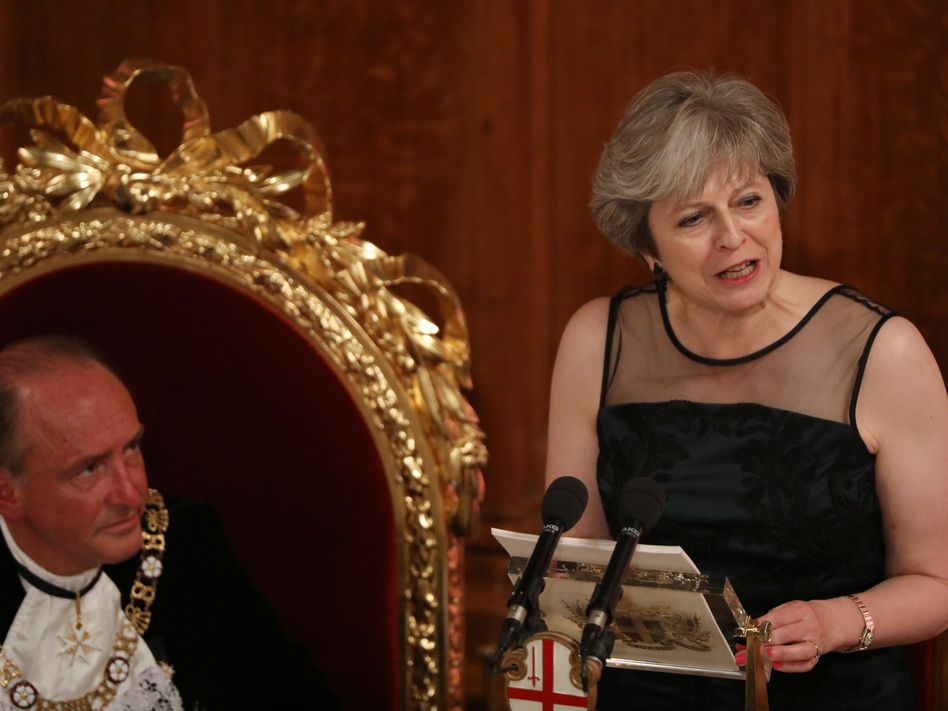 U.K. Prime Minister Theresa May speaks as Charles Bowman, Lord Mayor of the City of London, listens during the annual Lord Mayor's Banquet at the Guildhall, in the square mile financial district of the City of London on Monday. (Bloomberg/Bloomberg via Getty Images)