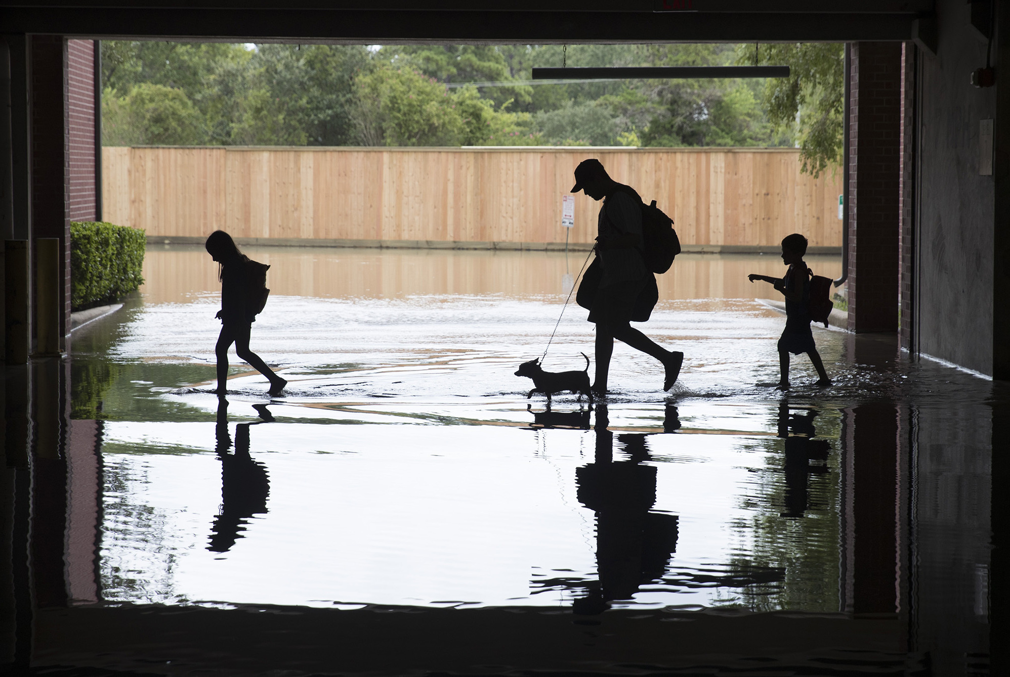 A family evacuated their apartment complex in west Houston, where high water coming from the Addicks Reservoir flooded the area after Hurricane Harvey on Aug. 30th. (Getty Images)