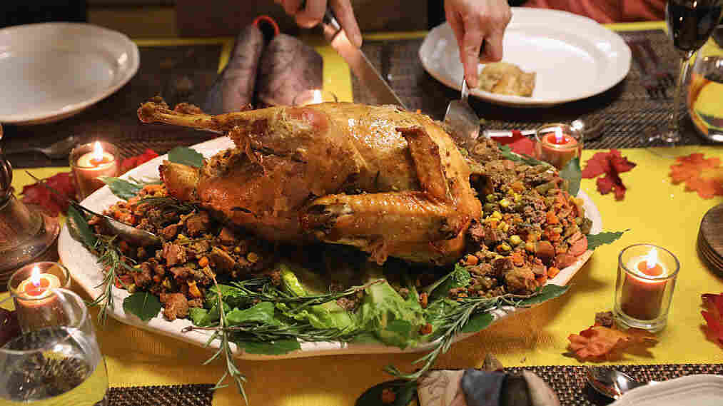 A Guatemalan immigrant carves the Thanksgiving turkey in November 2016 in Stamford, Conn.